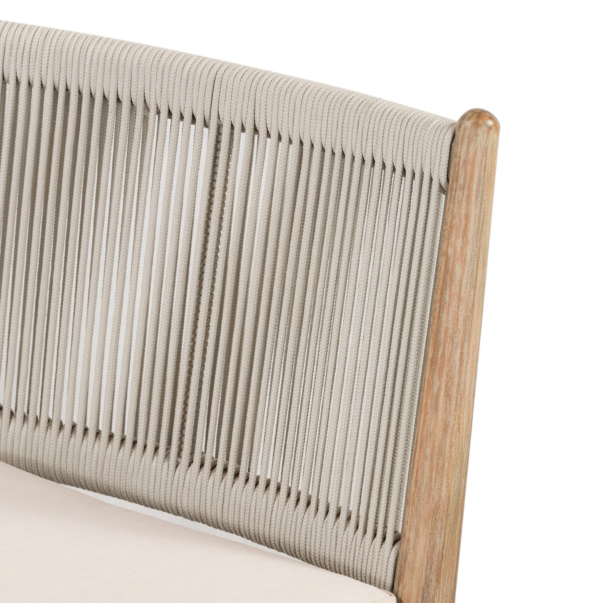 Close-up of a chair's seat back with woven design and wooden frame on a white background