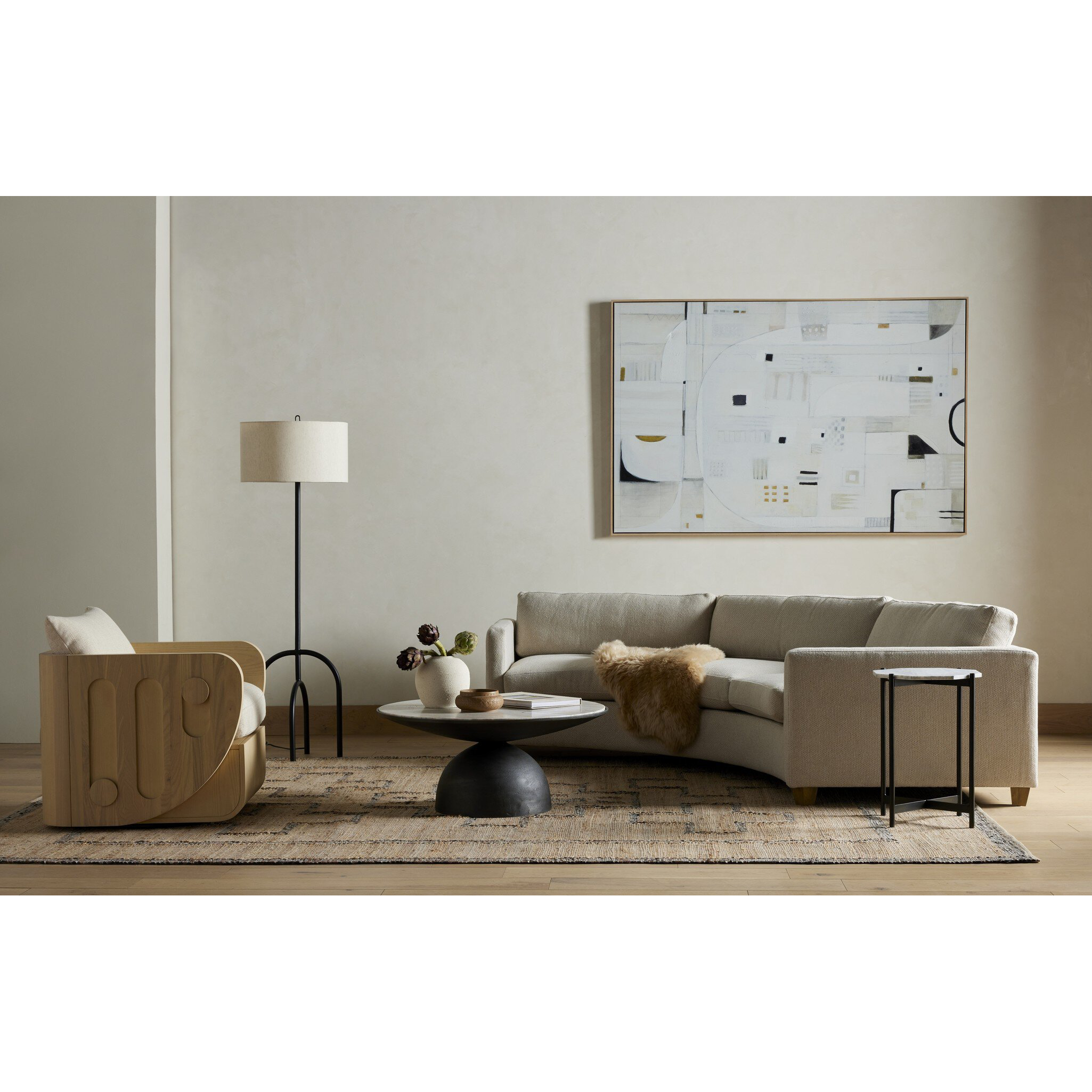 Modern living room with a beige sofa, armchair, and abstract painting on the wall.