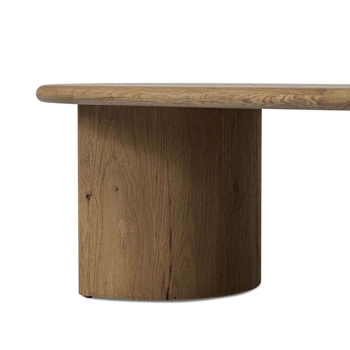 A close-up of a round wooden table featuring a thick cylindrical pedestal base and a live-edge tabletop, shown against a plain white background.