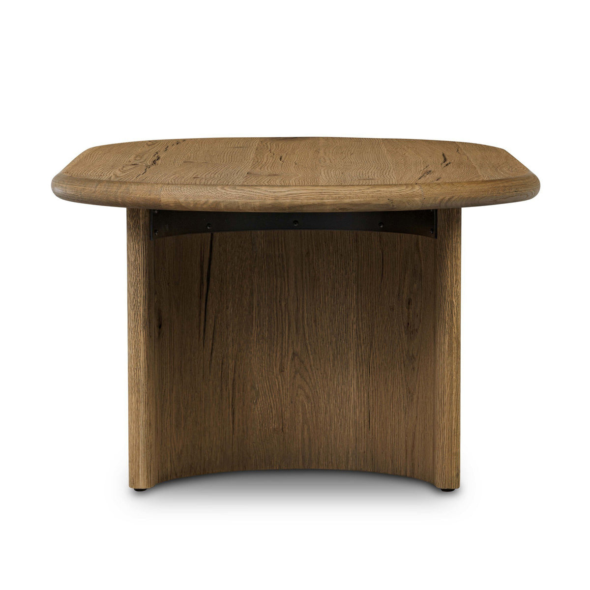A round wooden table with a medium brown finish, featuring a thick curved top and a matching curved pedestal base with a black metal support bracket underneath, shown on a plain white background.