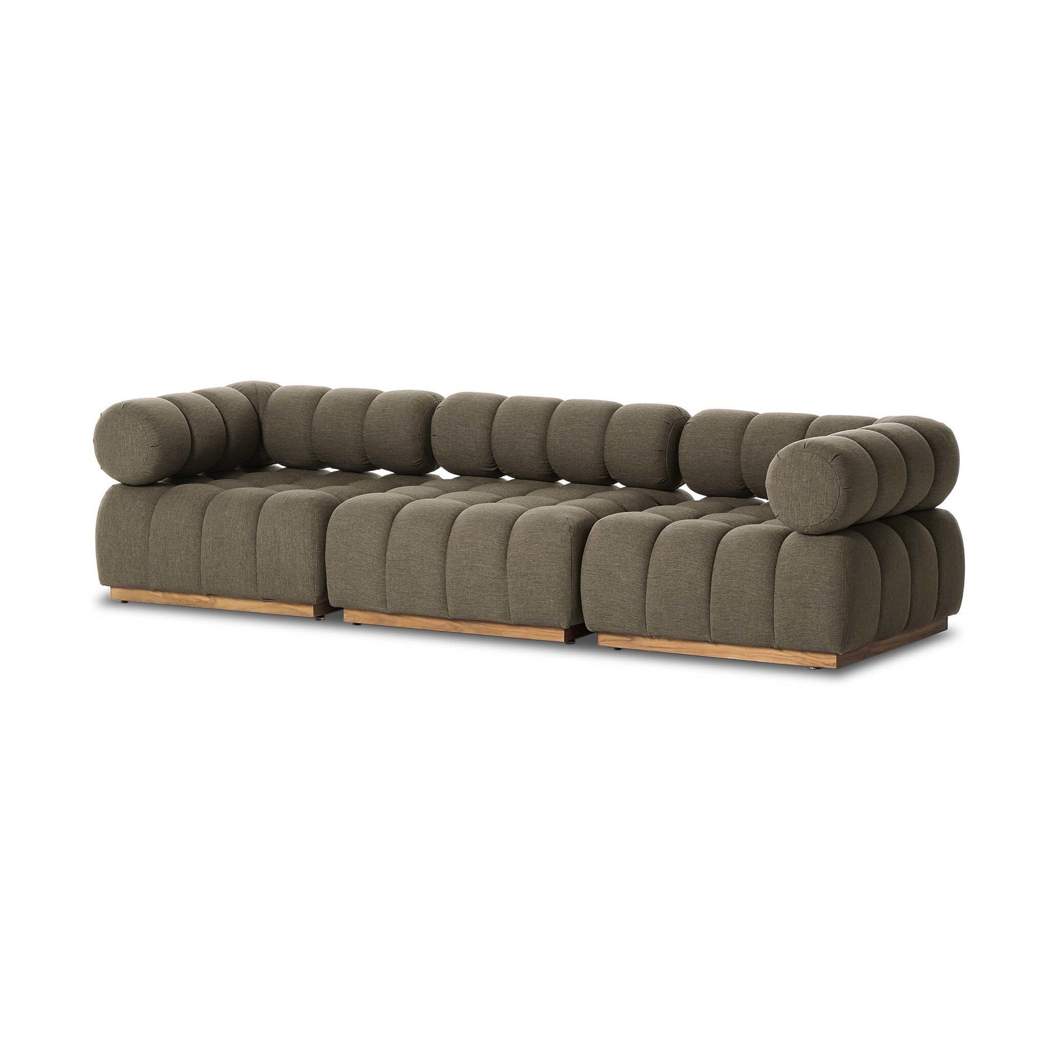 Modern olive green sofa with wooden legs on a white background