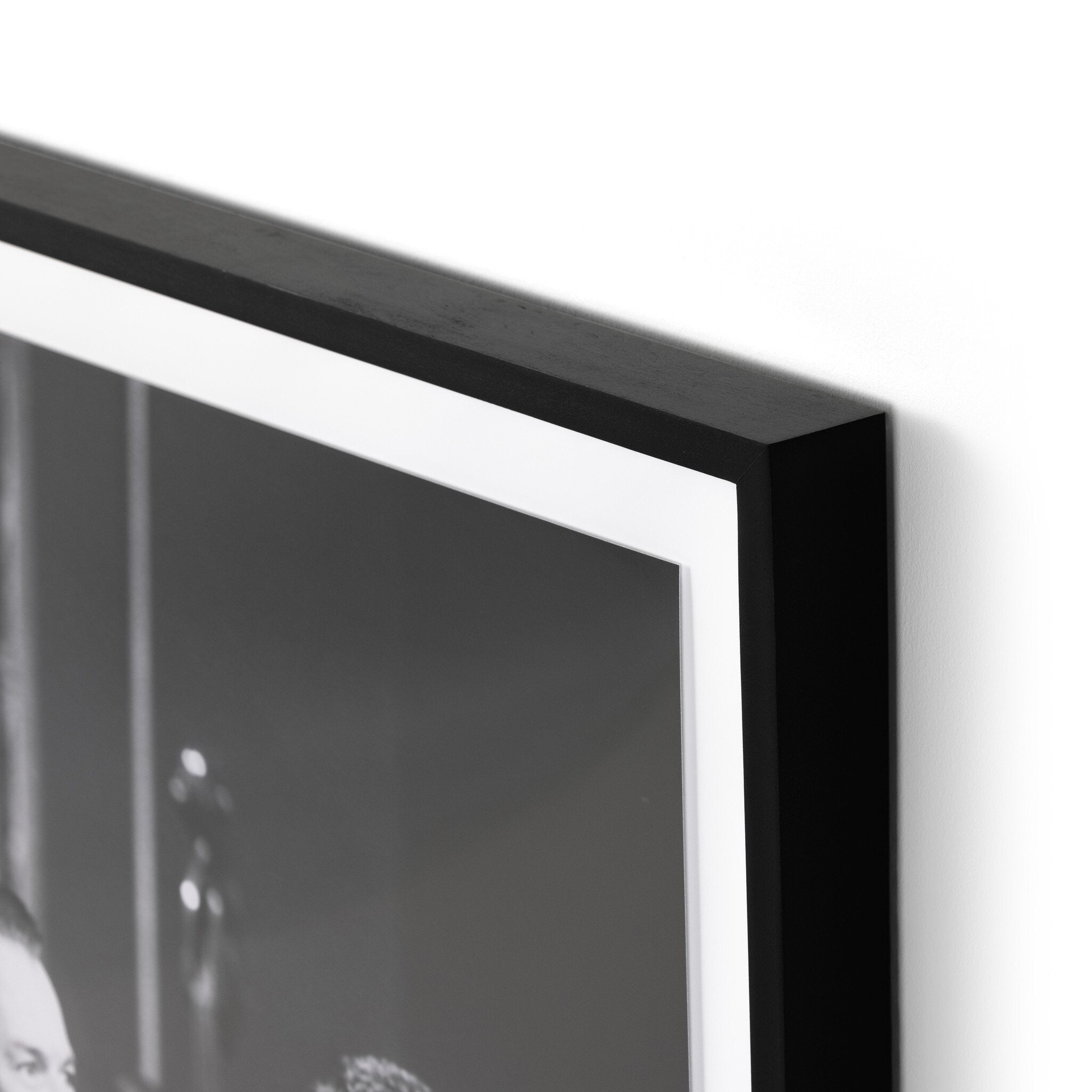 Close-up of a black picture frame corner on a white background