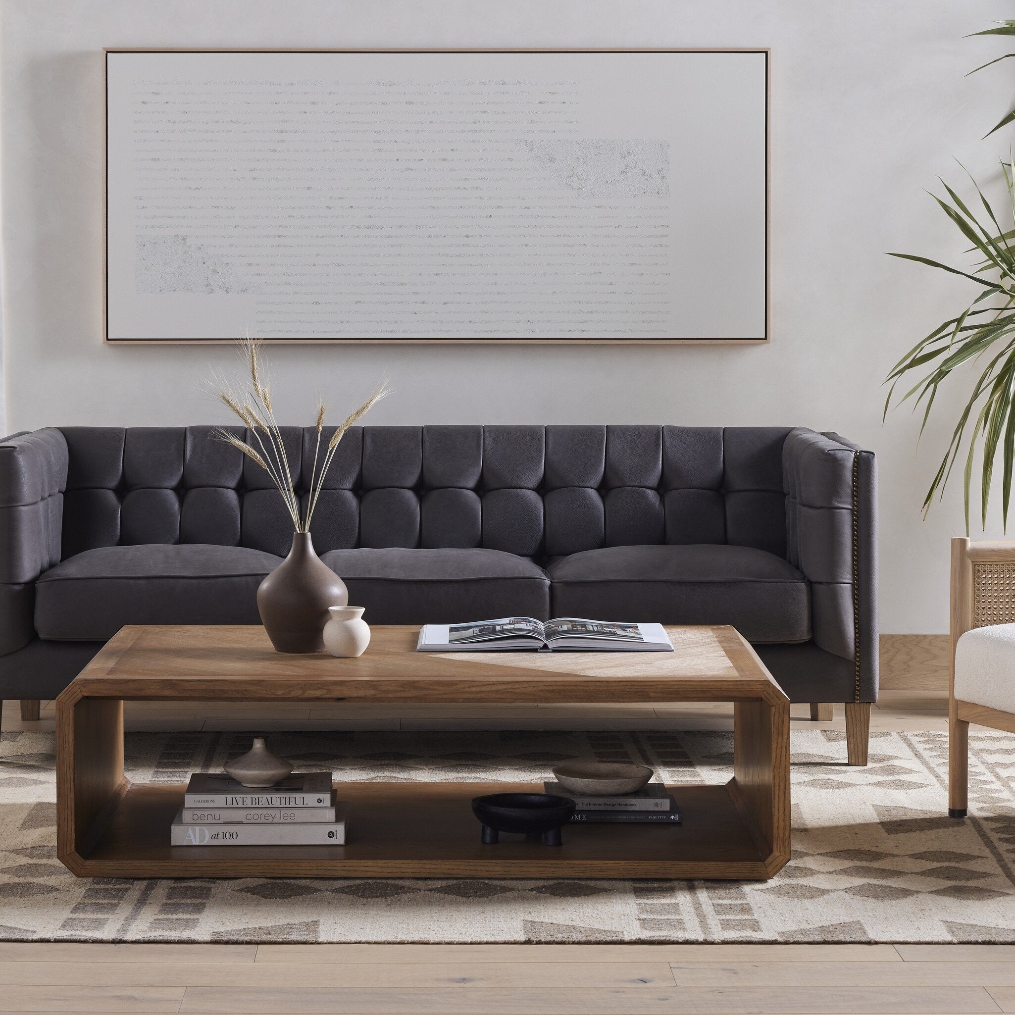 Modern living room with a gray sofa, wooden coffee table, and decorative elements.