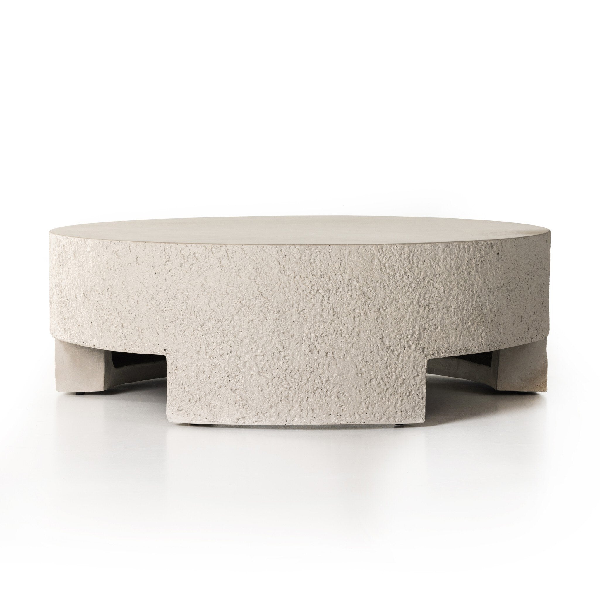 Round textured outdoor coffee table on a white background