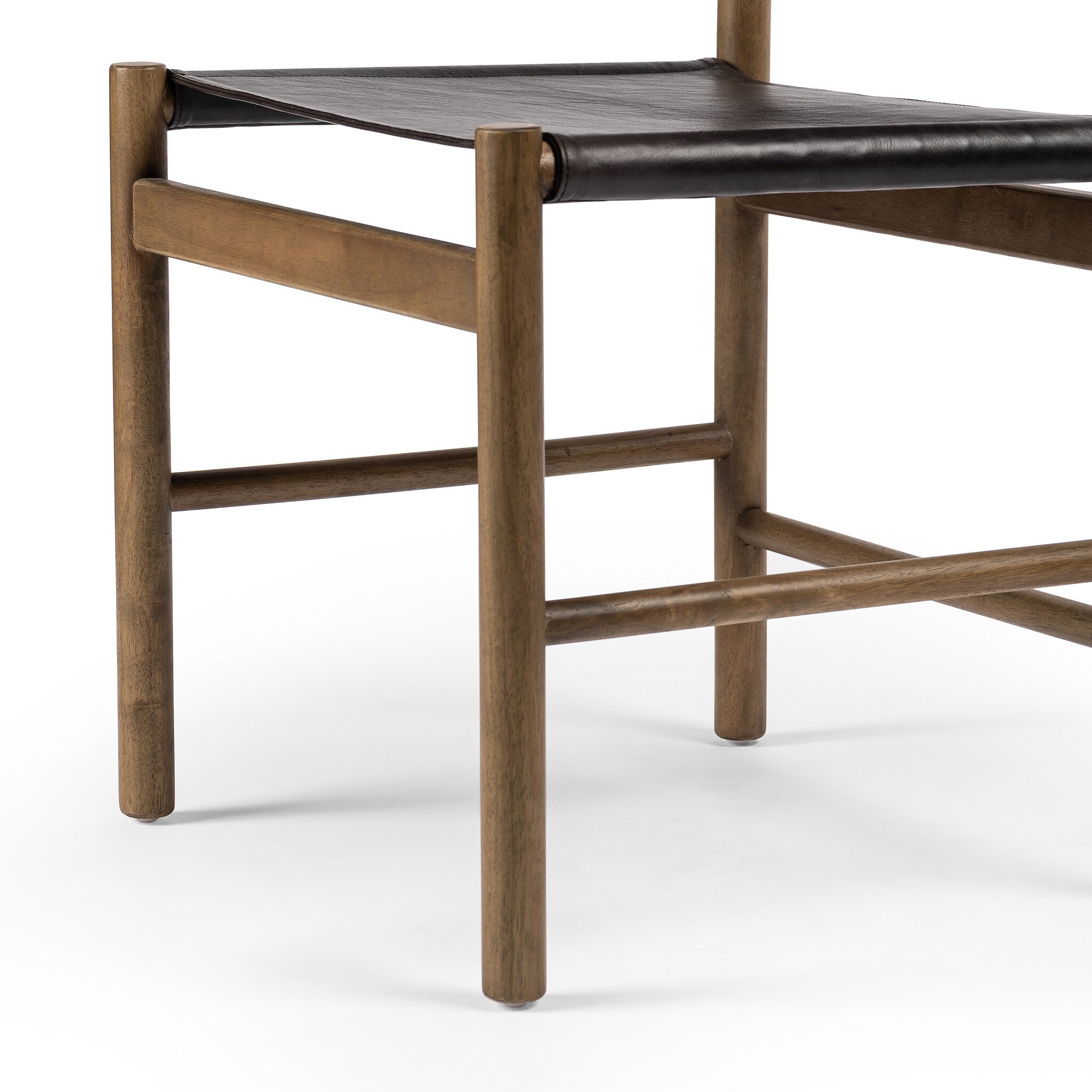 Wooden chair with a black leather seat on a white background