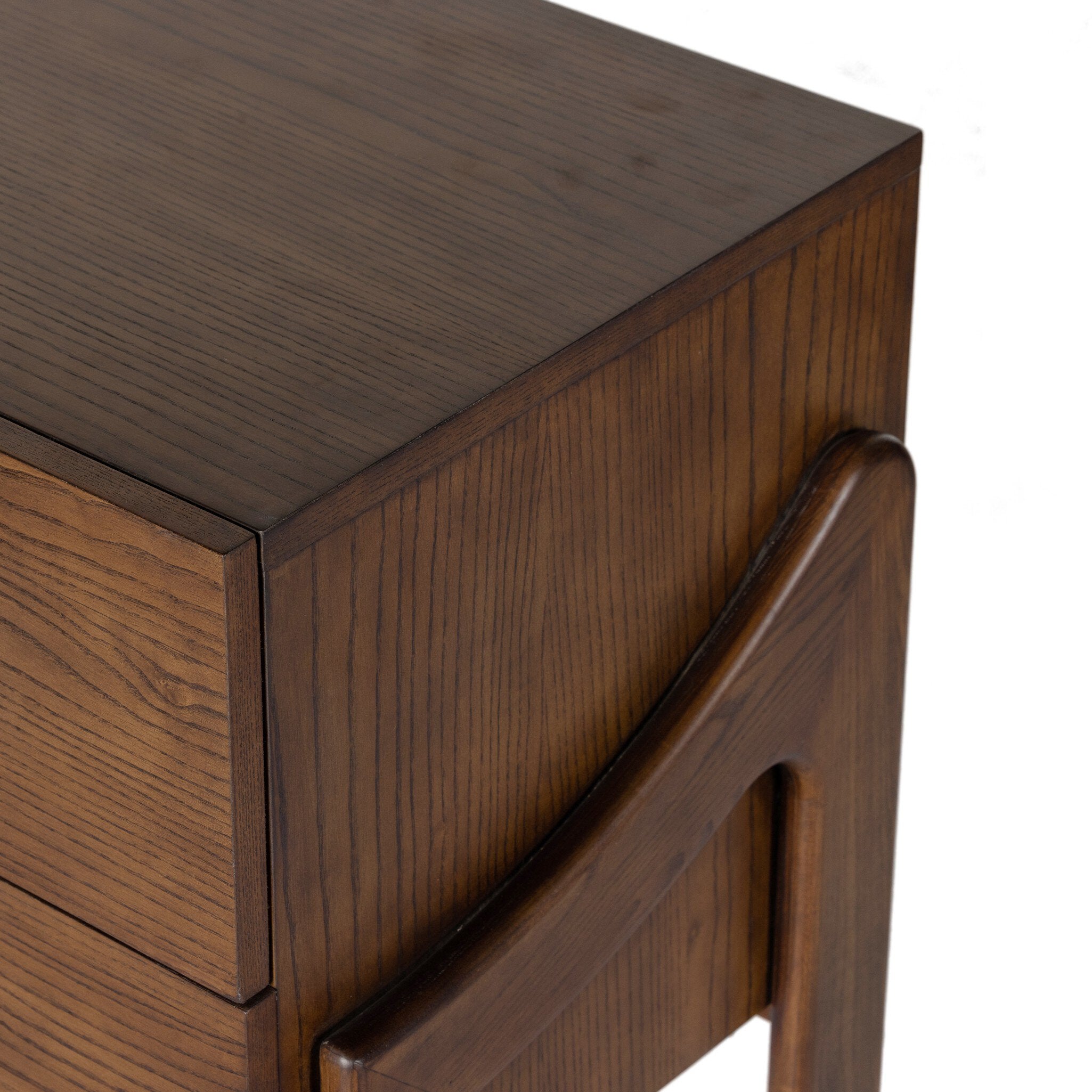Close-up of a wooden side table with a drawer and curved handle.