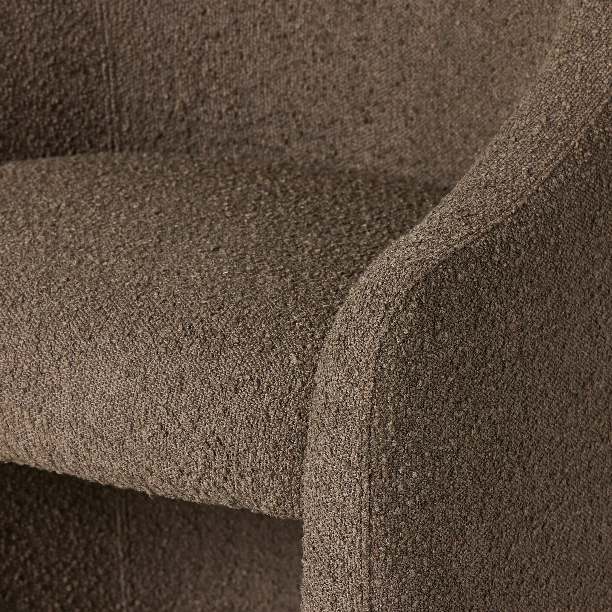 Close-up of brown boucle upholstered dining chair