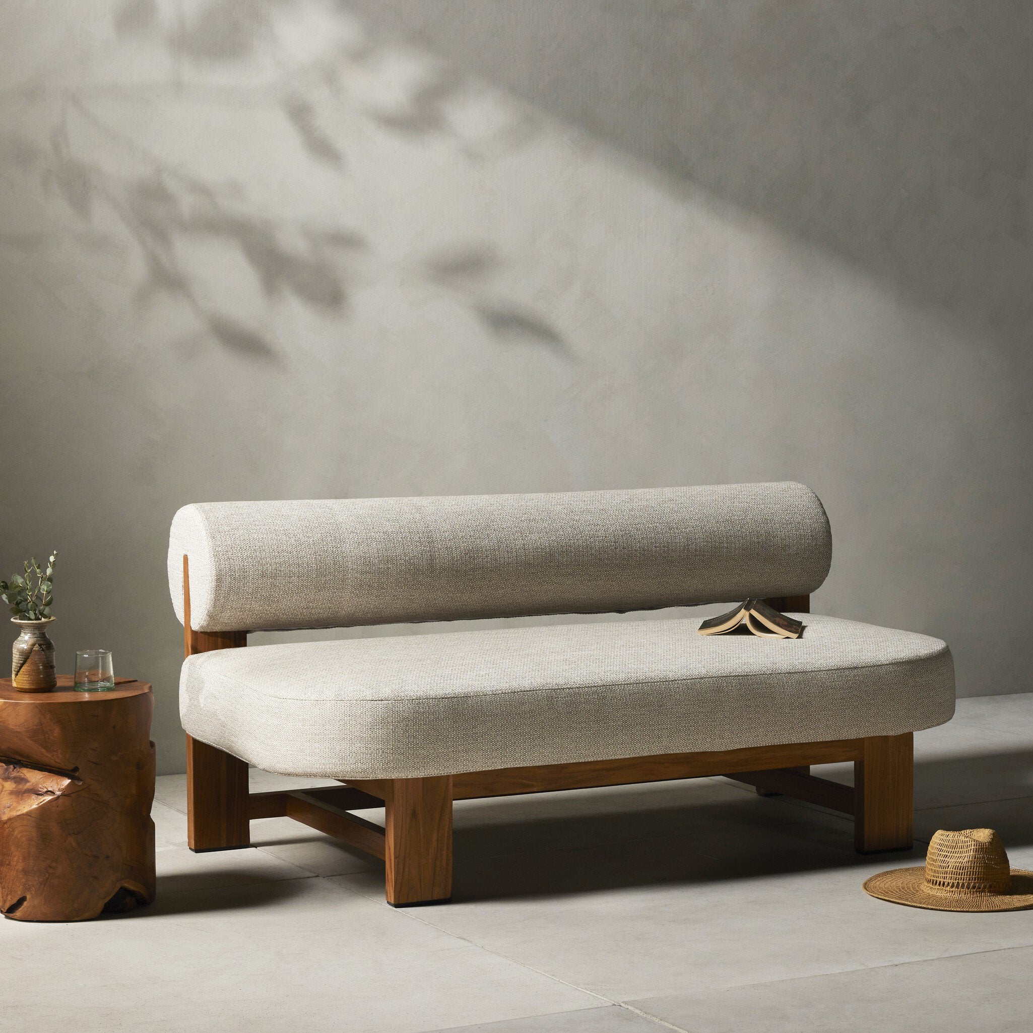 Beige sofa with wooden legs in a minimalistic room setting