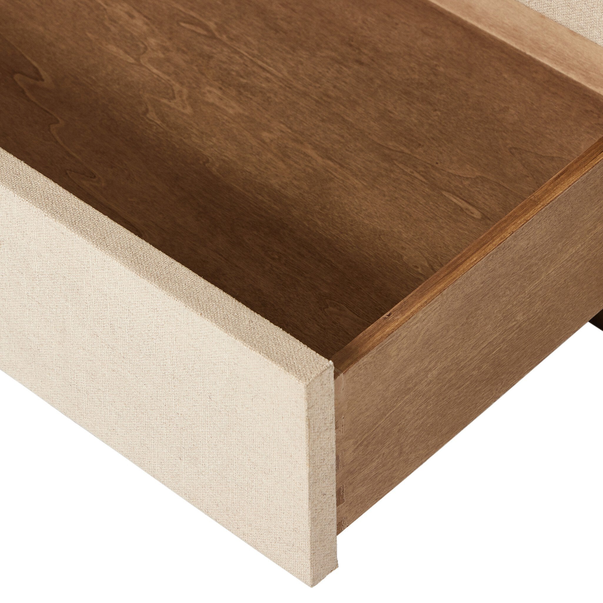 Close-up of a wooden drawer with a visible grain pattern on a white background