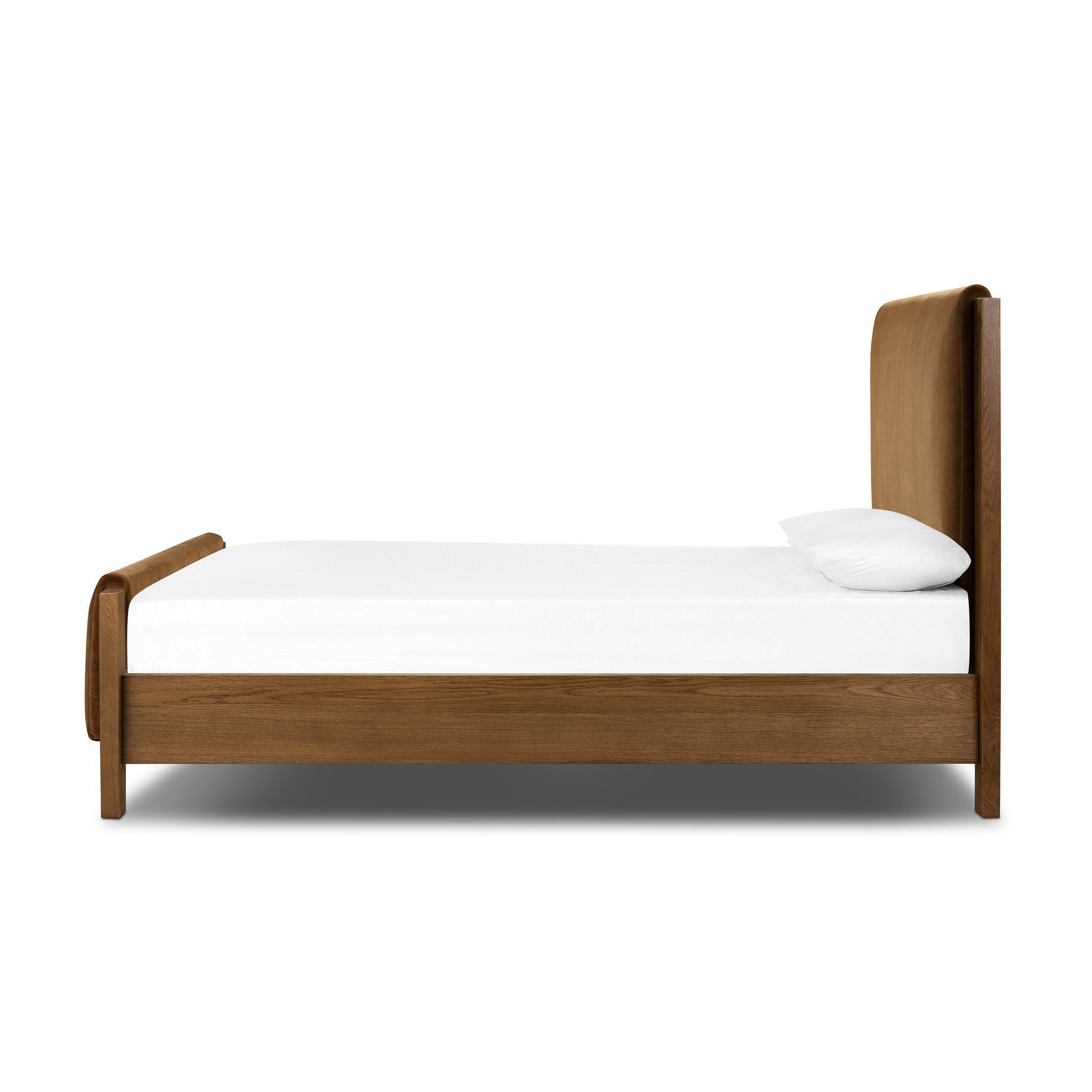 Wooden and upholstered velvet bed with white mattress and pillow on a white background