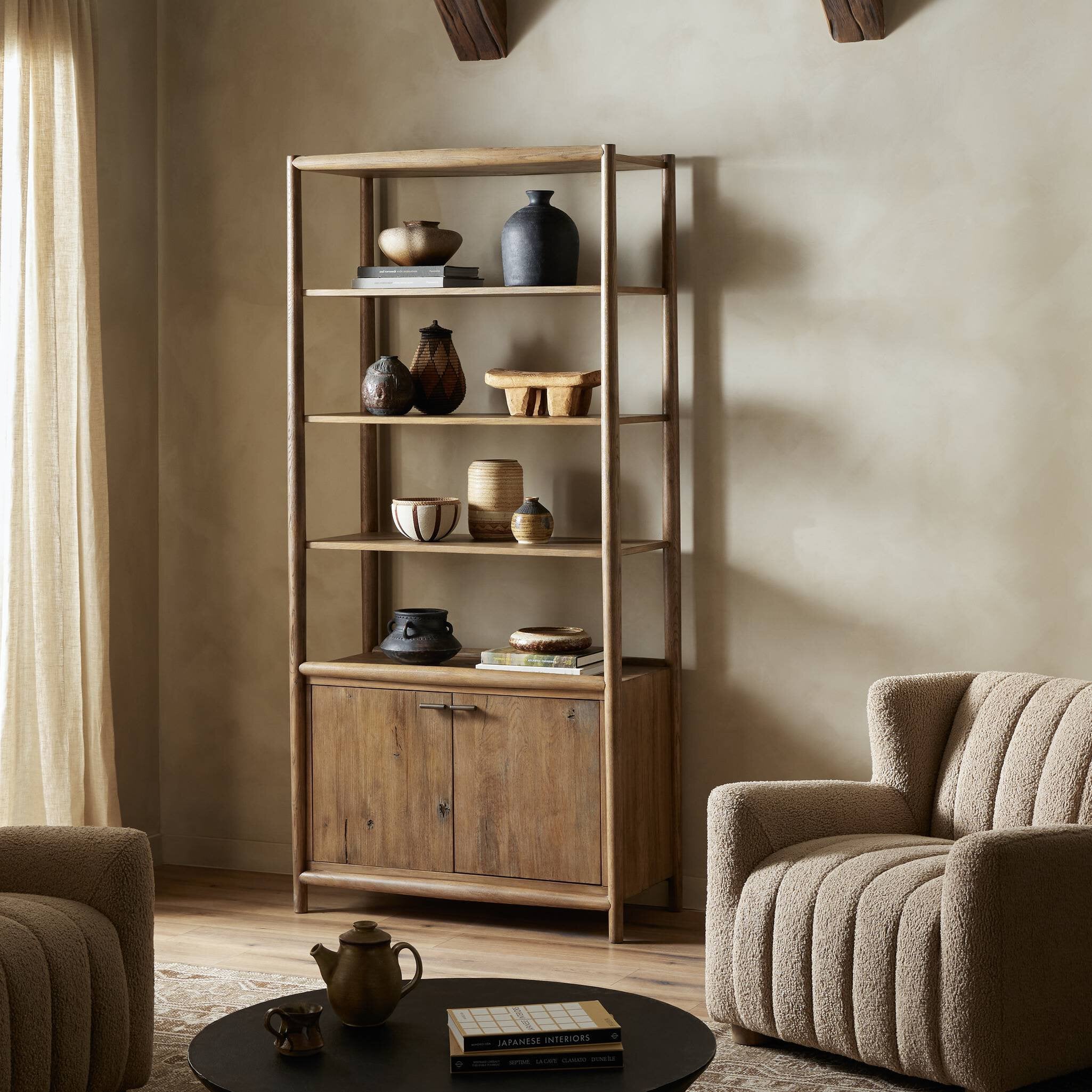 Wooden bookshelf with decorative items in a living room setting