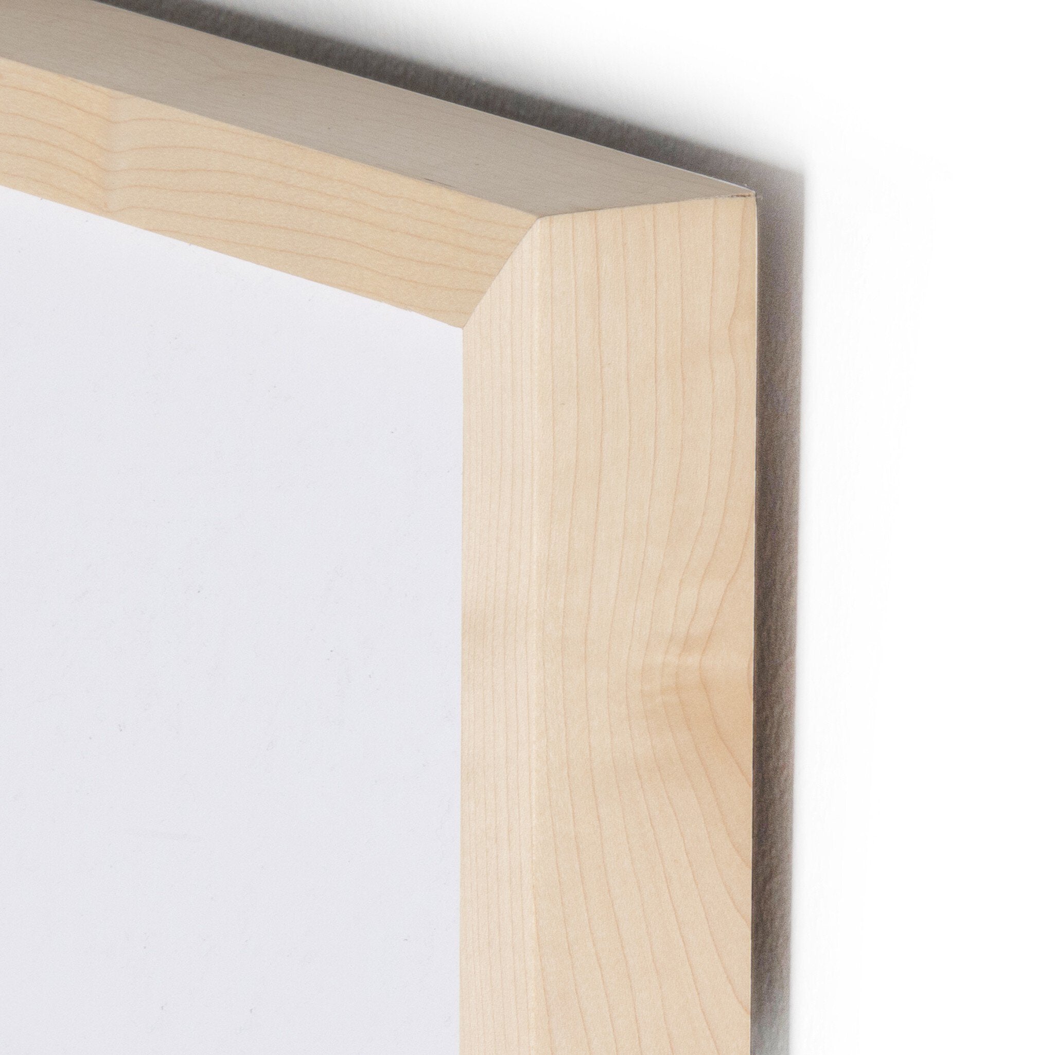 Close-up of a wooden picture frame corner on a white background