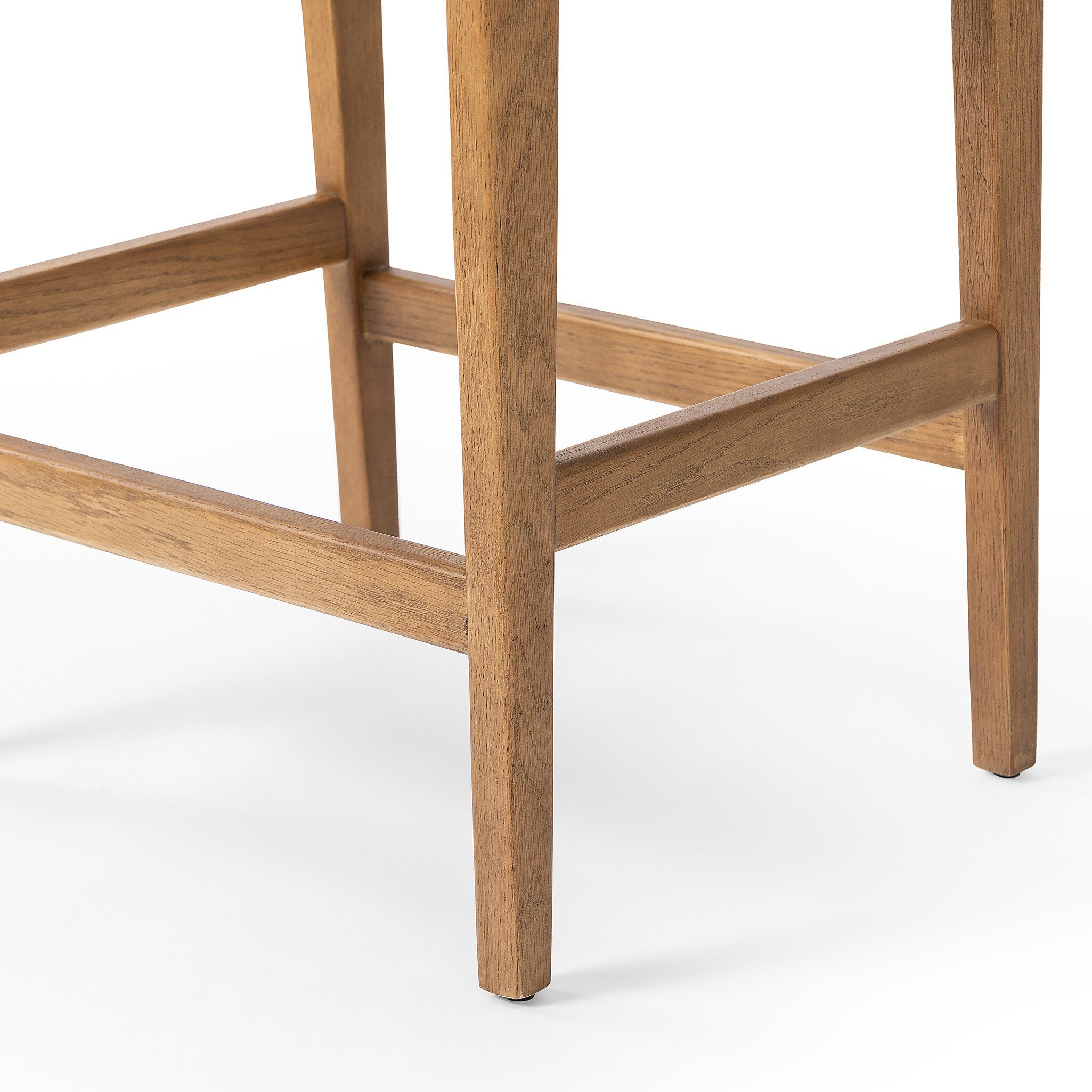Wooden bar stool with a beige cushioned seat on a white background