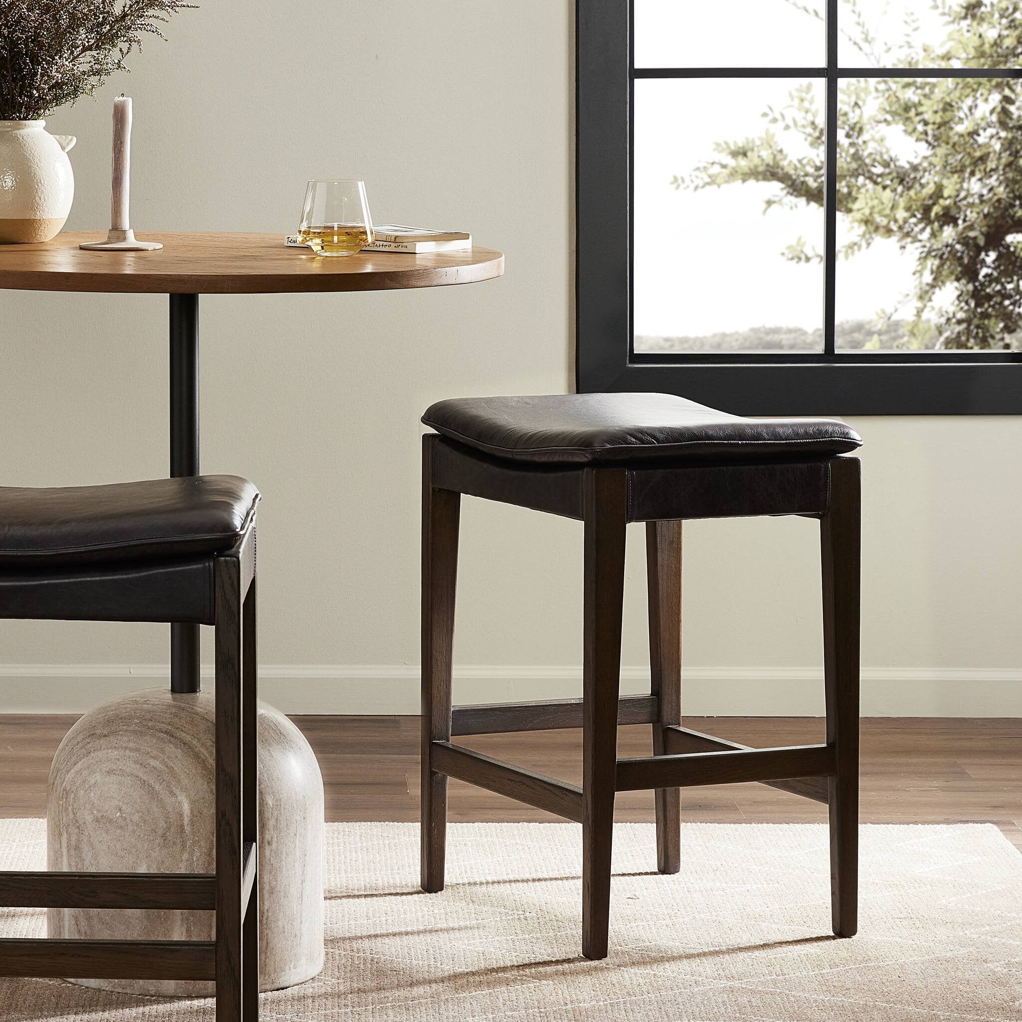 Bar stool with black leather seat and wooden frame