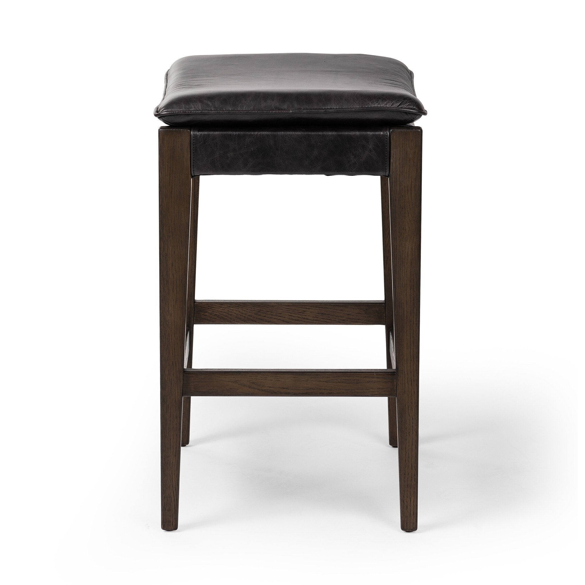 Wooden stool with black leather seat on a white background