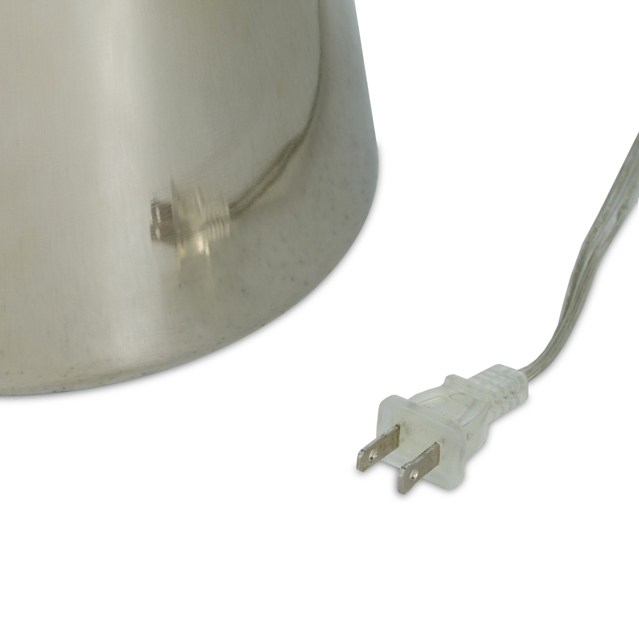 Close-up of a lampshade with a clear cord and white plug on a white background