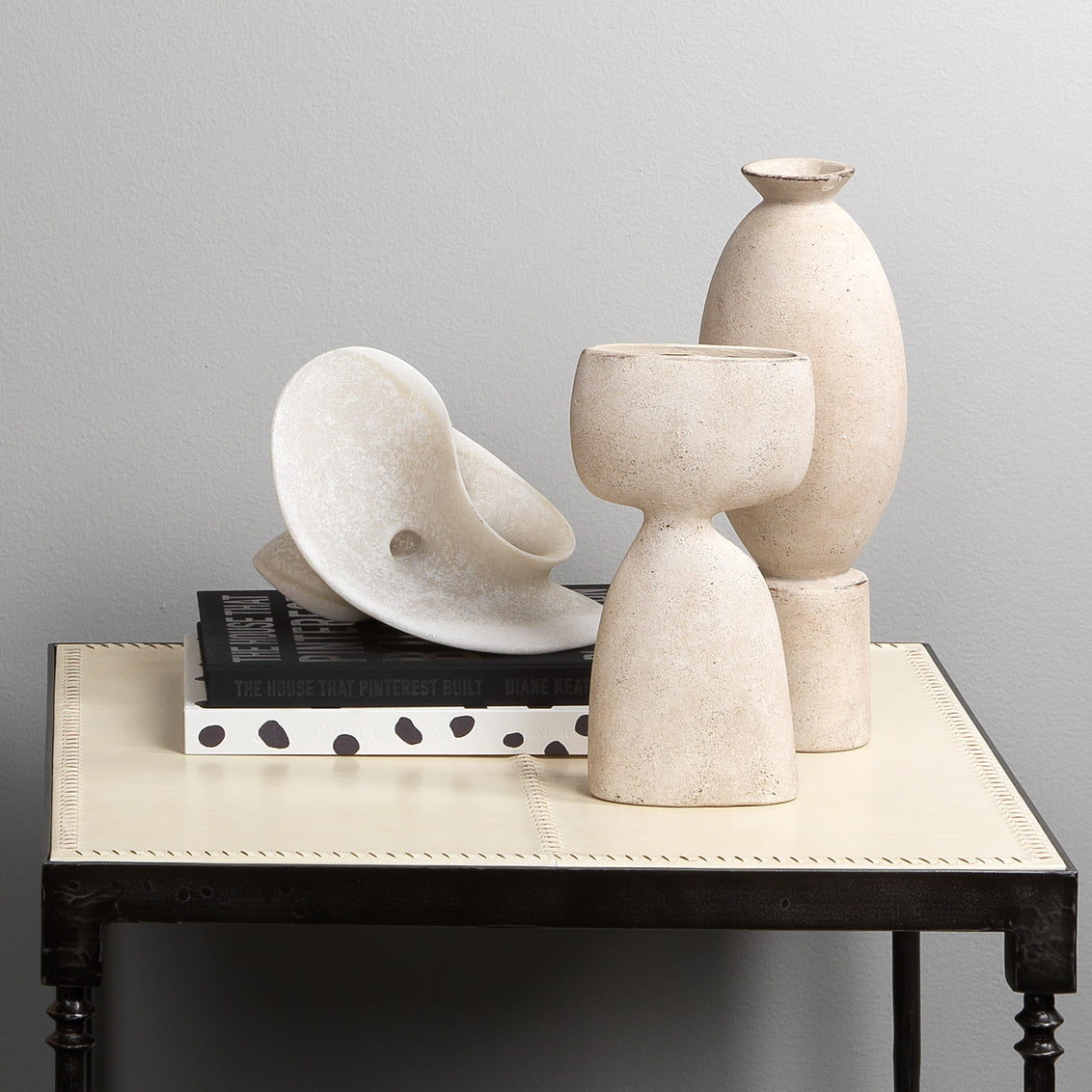 Set of ceramic vases on a table with a gray background