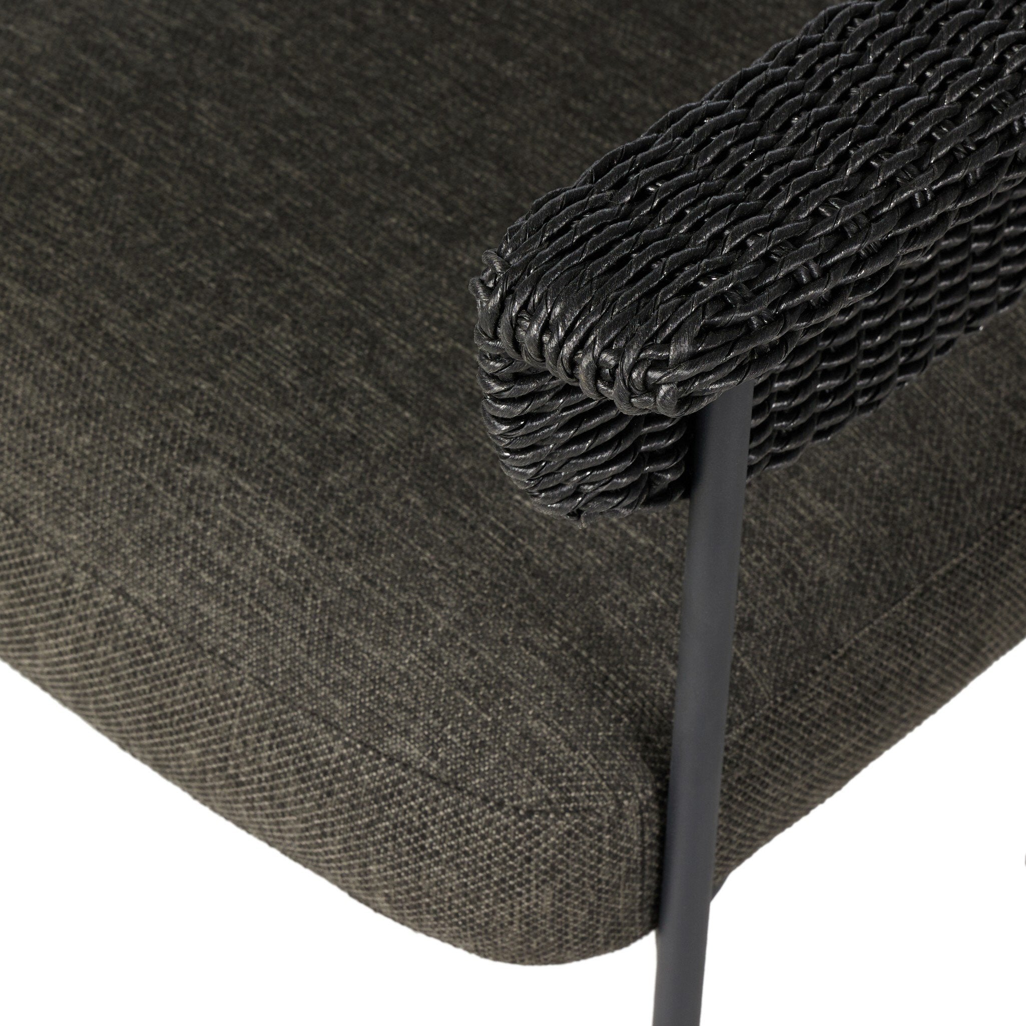 Close-up of a dark gray cushioned chair with woven backrest on a white background