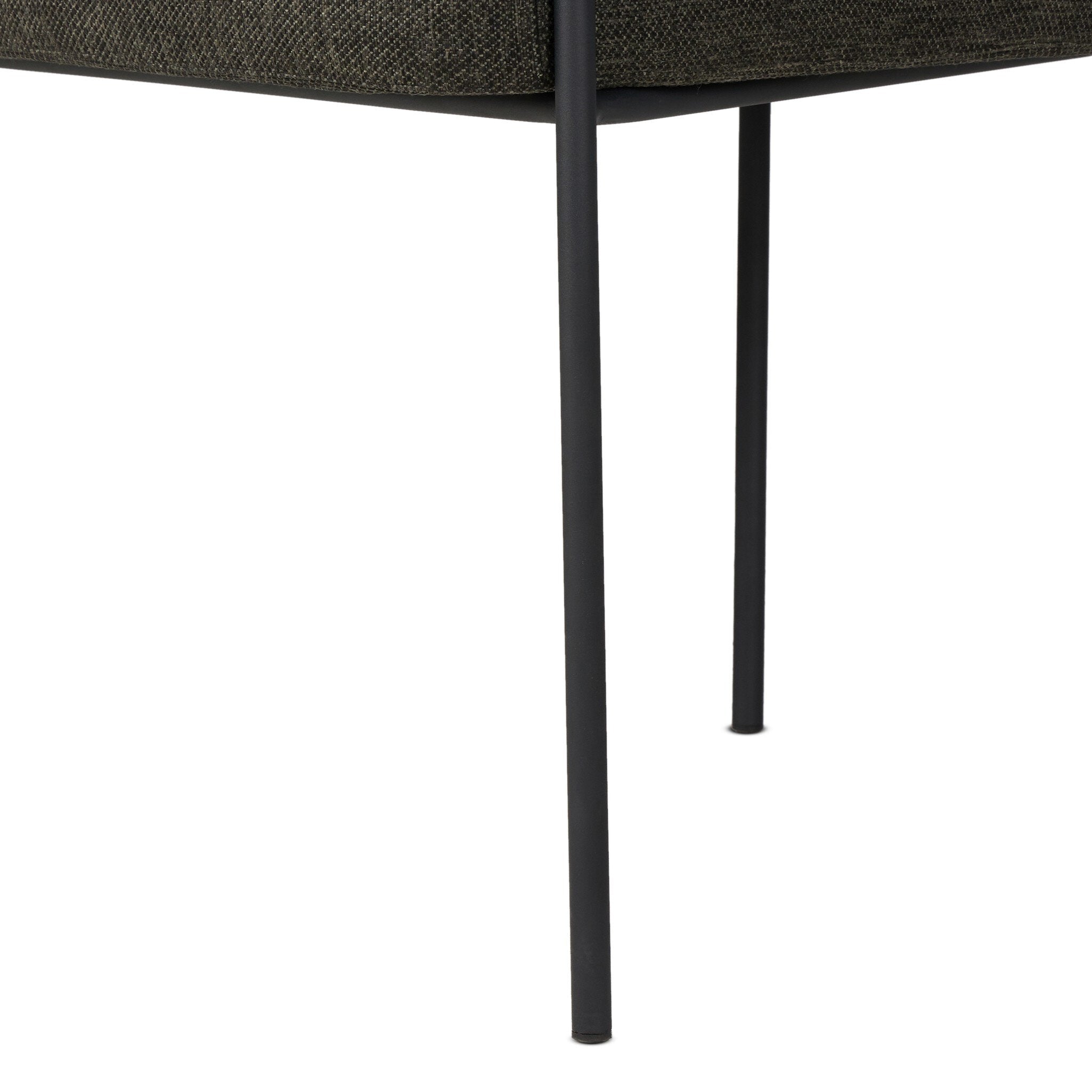 Close-up of a chair with a textured brown backrest and black metal legs on a white background