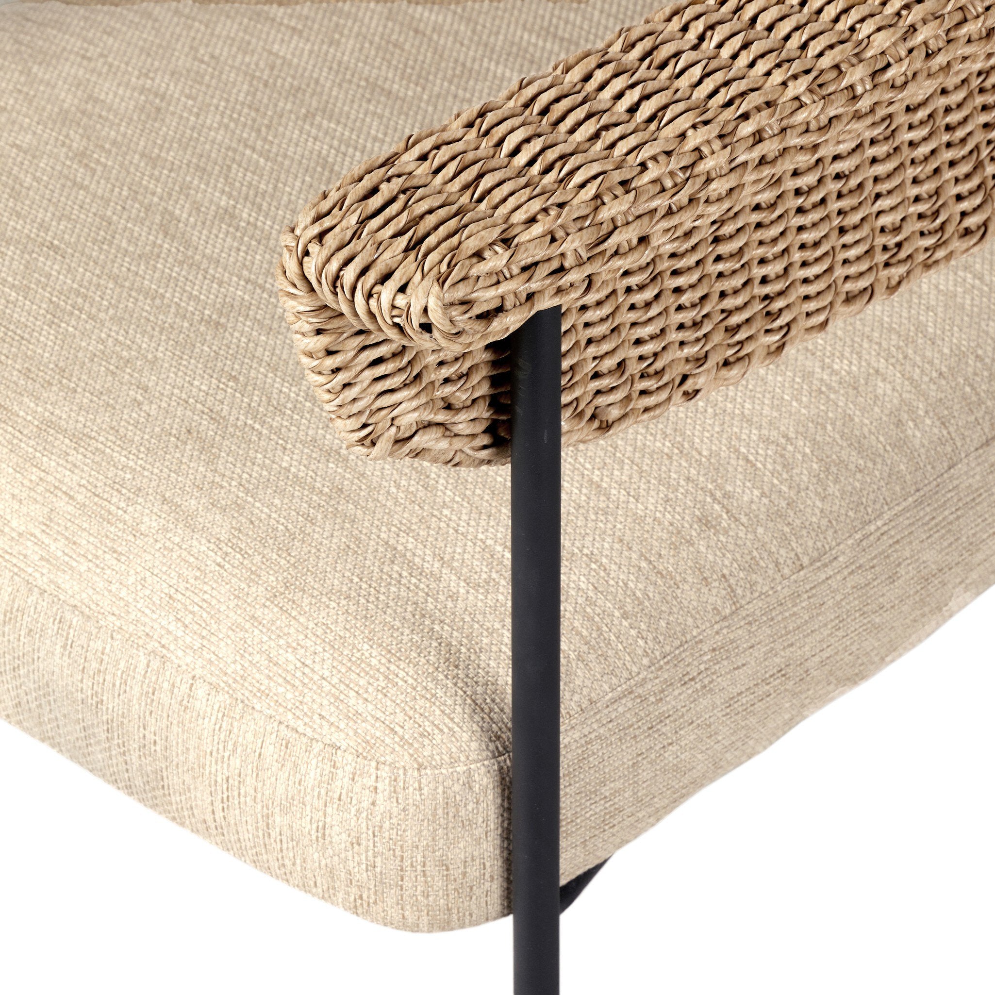 Beige cushioned bench with woven backrest on a white background