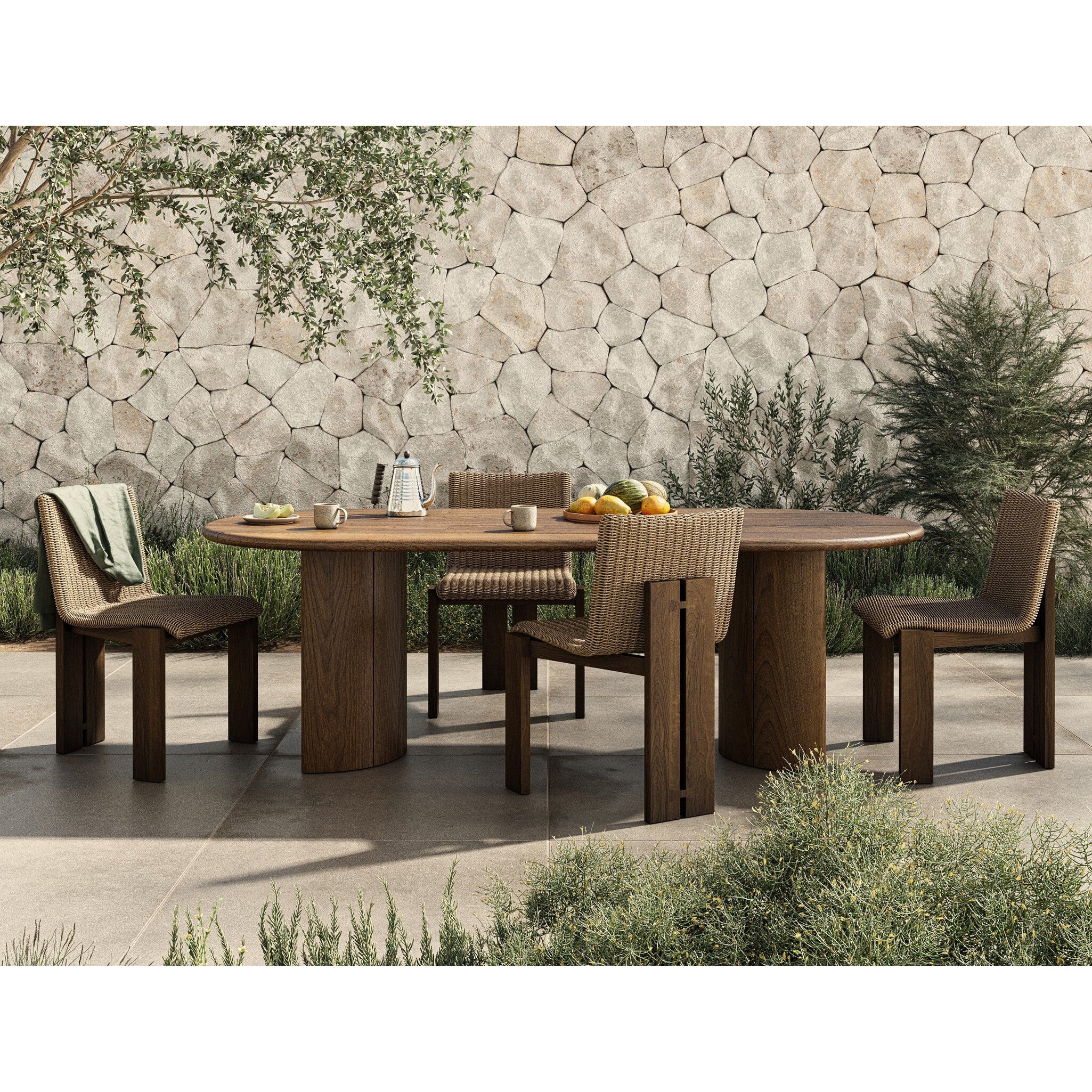 Outdoor dining set with wooden table and chairs against a stone wall.