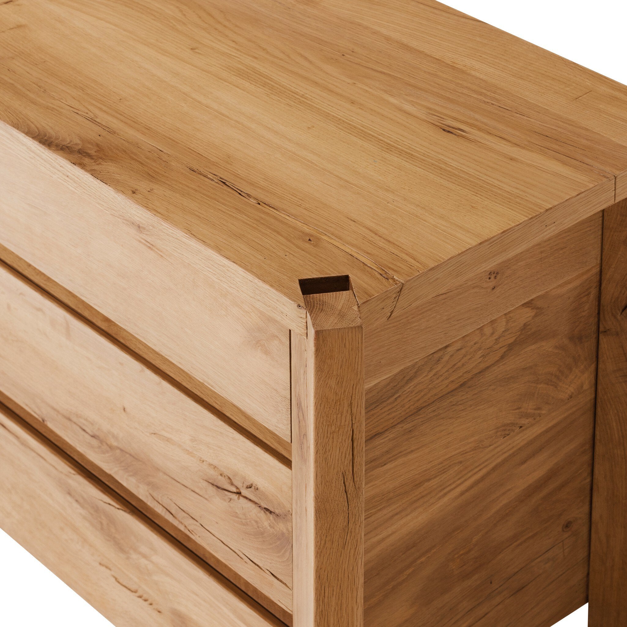 Close-up of a wooden drawer with a visible dovetail joint on a white background