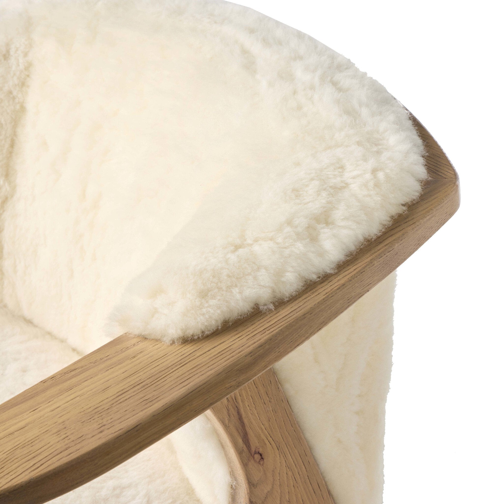 Wooden stool with a white sheepskin cover on a white background