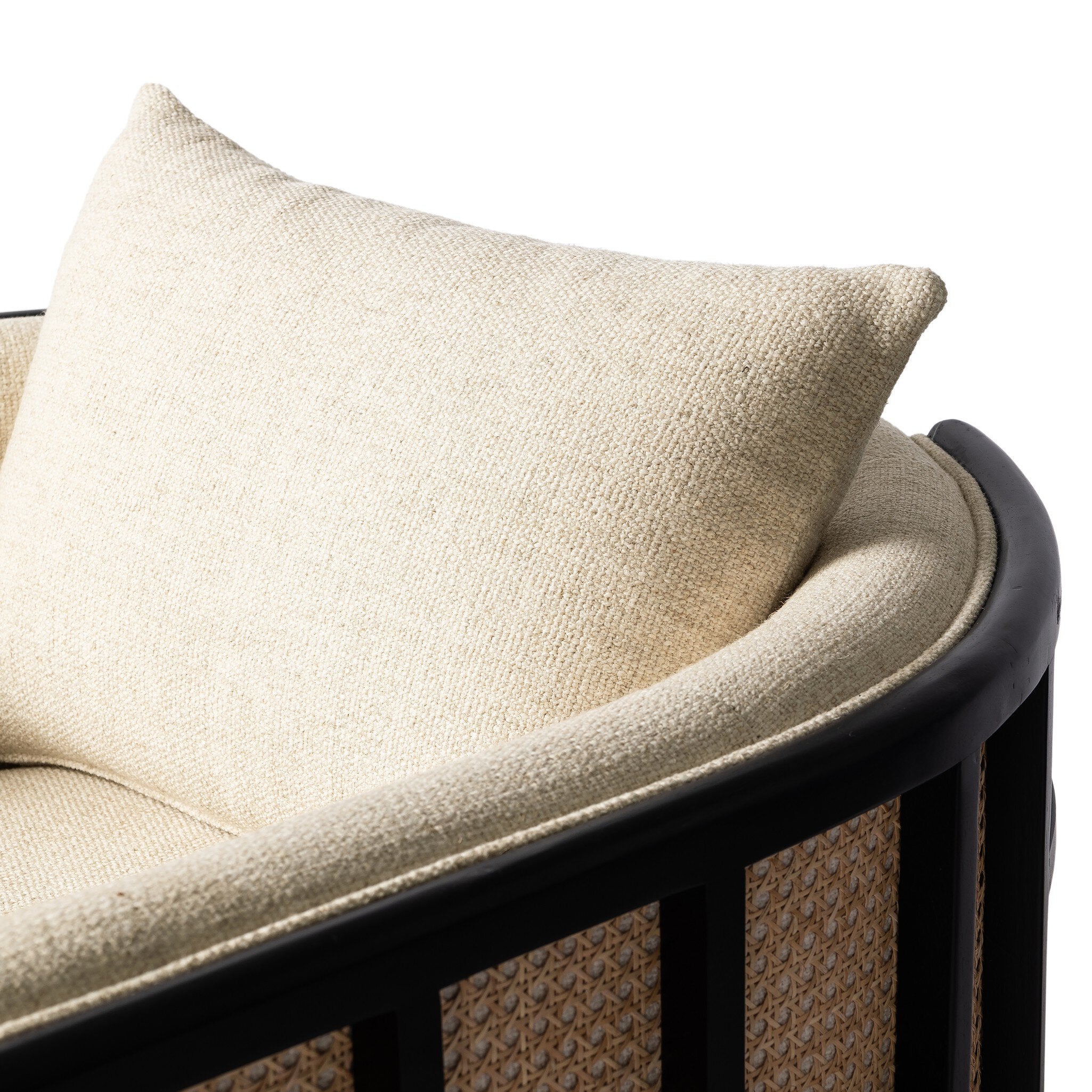 Beige cushion on a wicker chair with a white background
