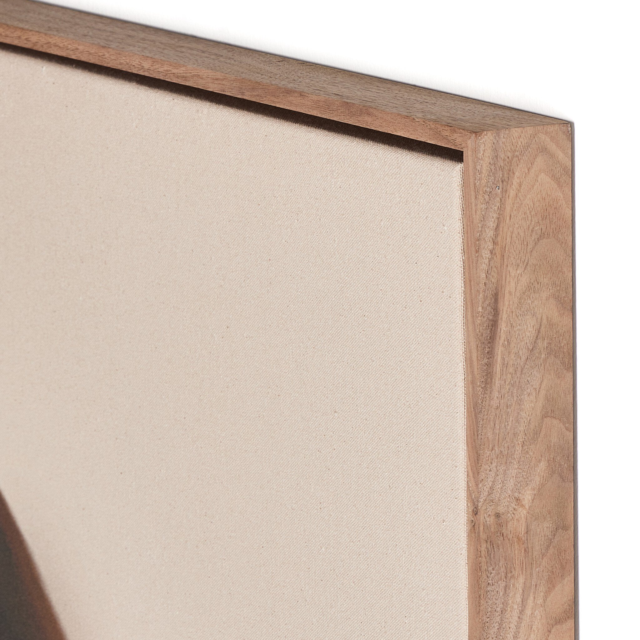 Close-up of a wooden picture frame corner with beige canvas background
