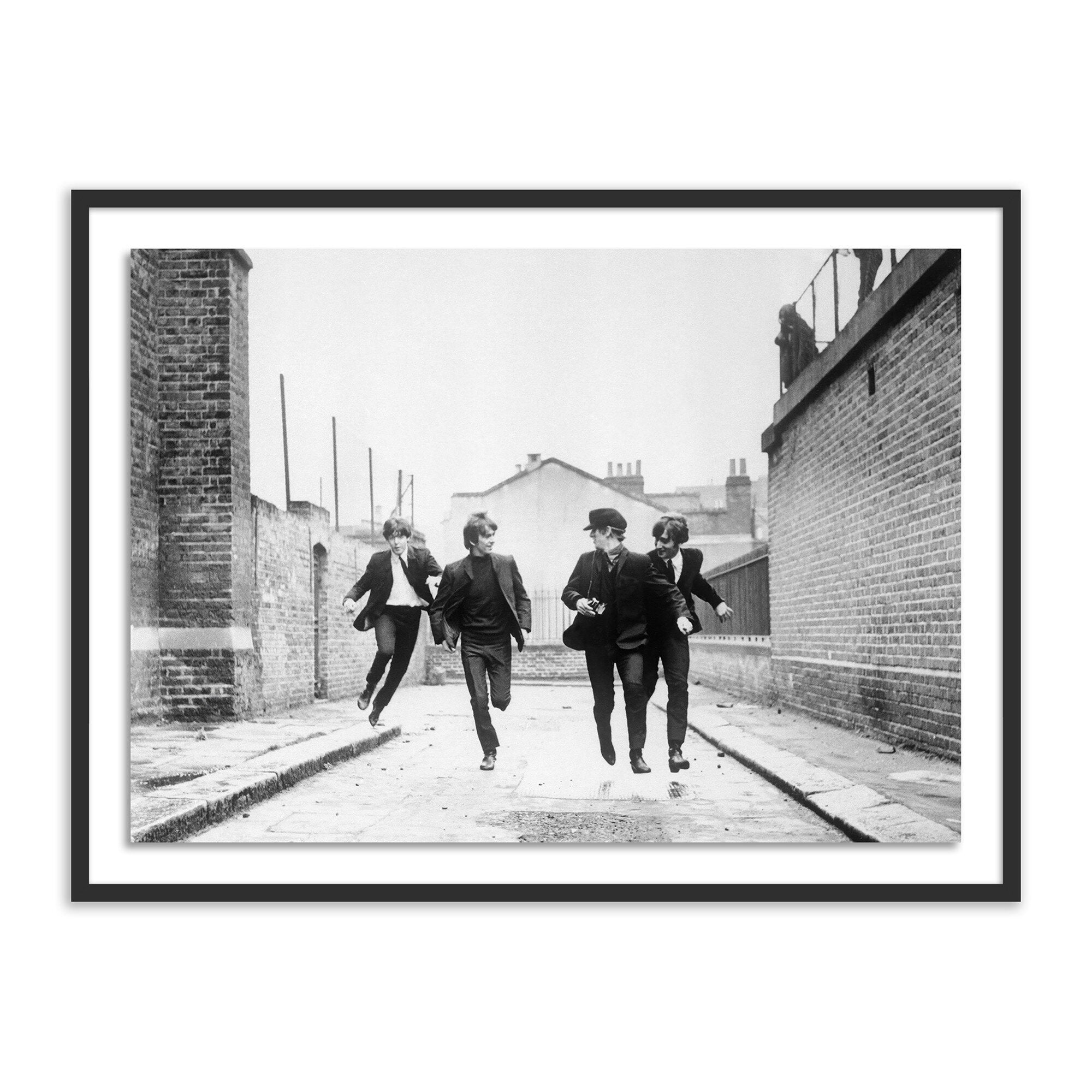 Framed black and white photo of The Beatles walking down a narrow alleyway.