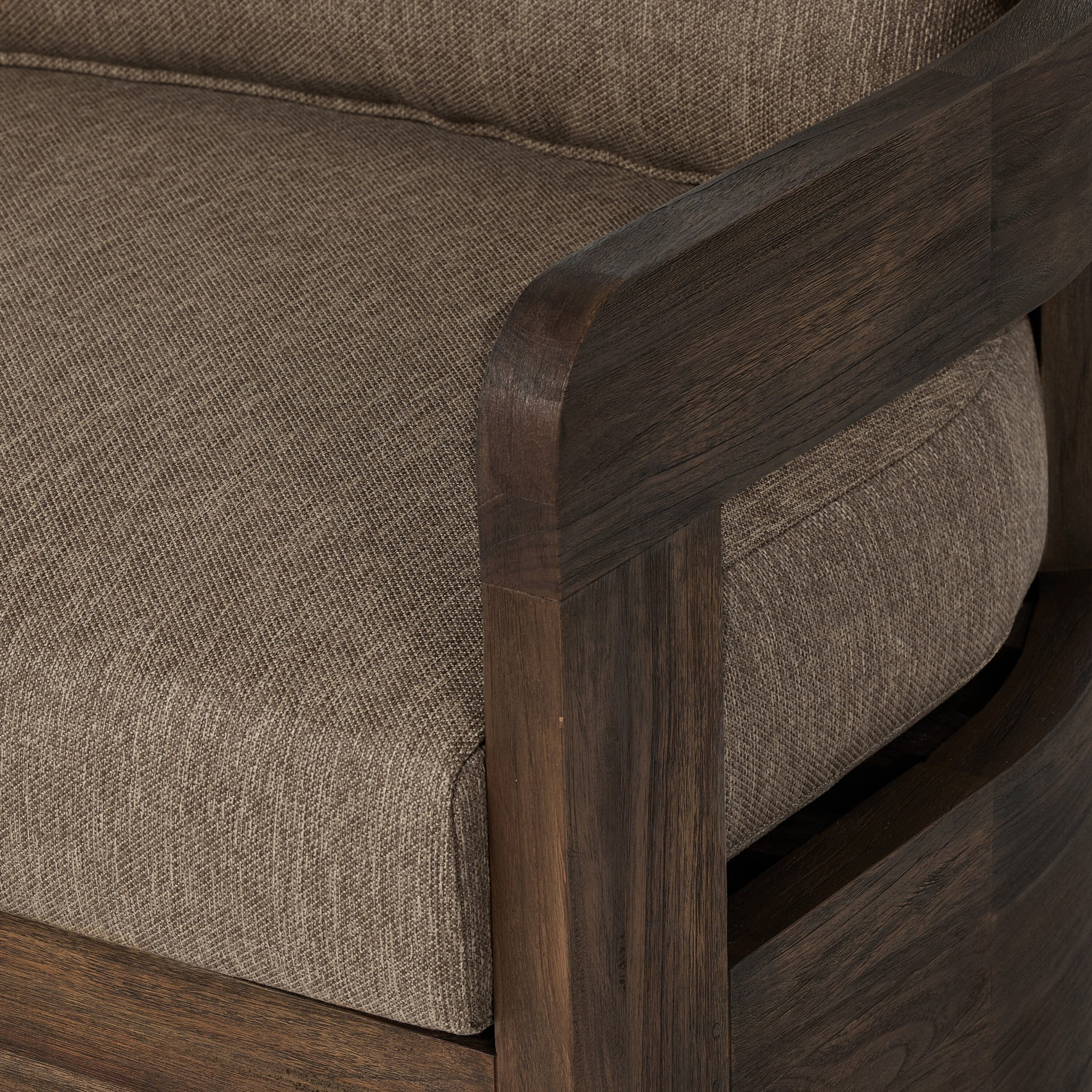 A brown upholstered Jackson Outdoor Swivel Chair with a teak wood frame and a cushion on it, against a white background.