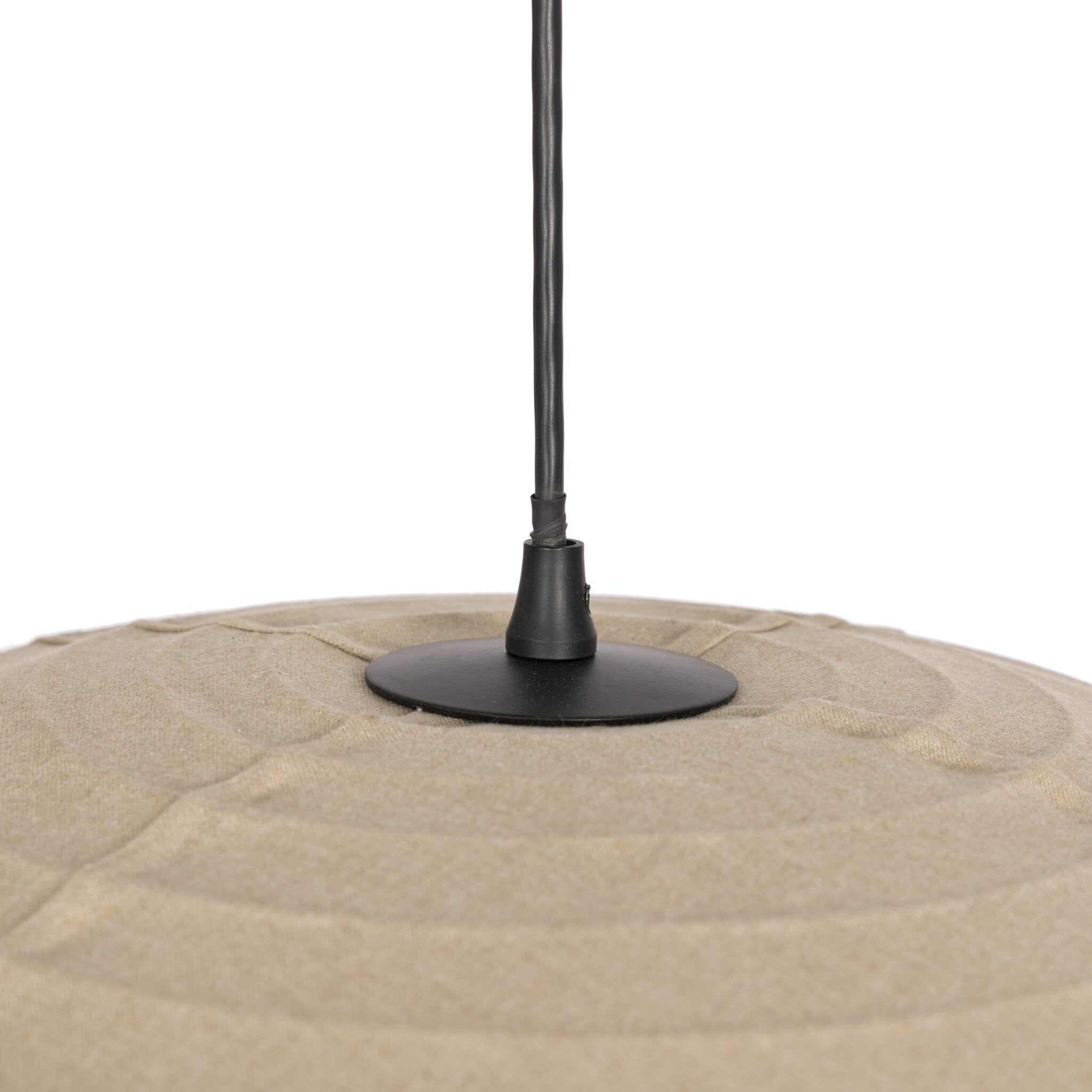 Black umbrella stand on a beige sand-like surface with a white background