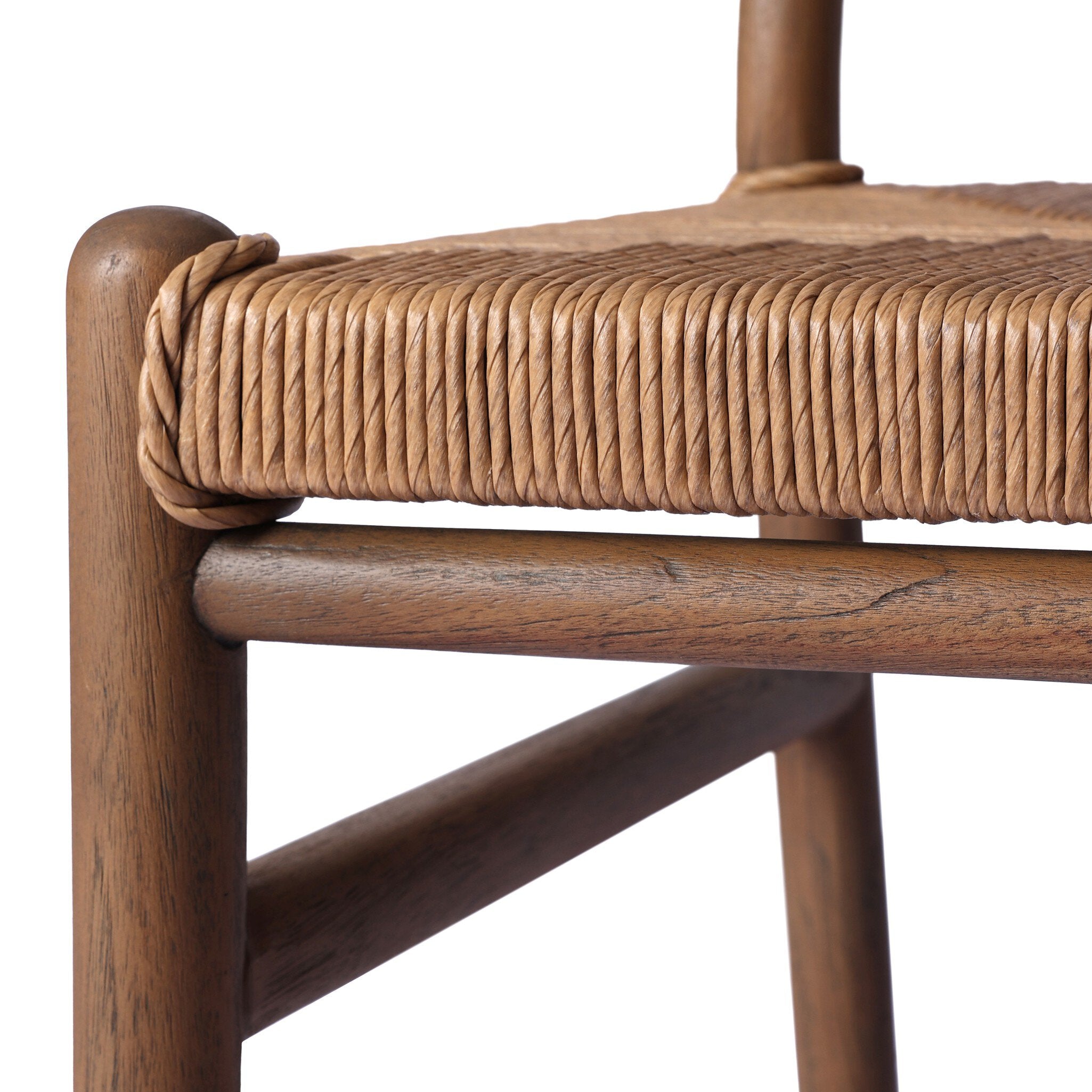 Close-up of a wooden chair with woven seat on a white background