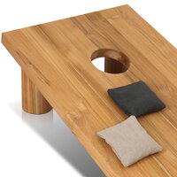 Wooden cornhole board with two bags on a white background