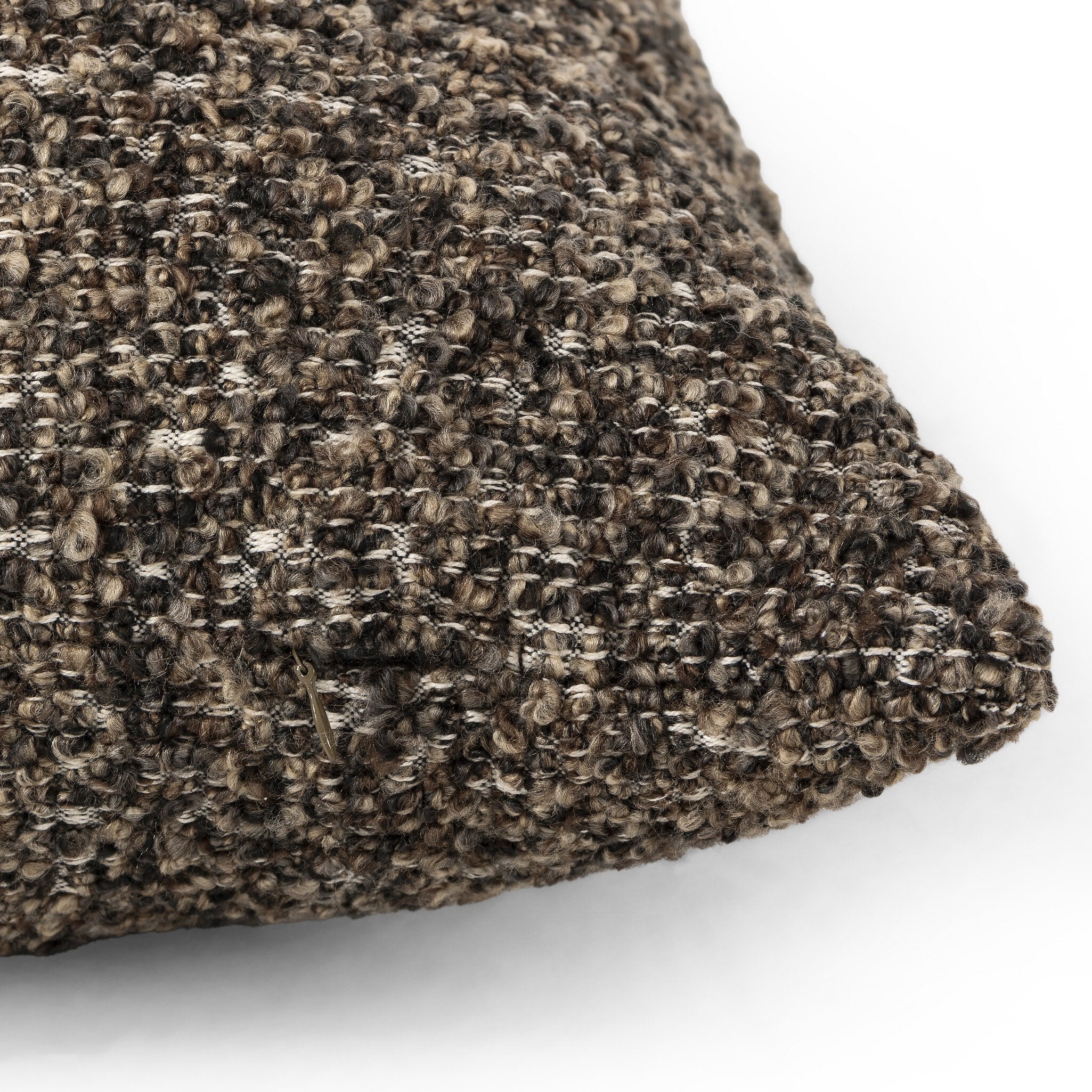 Close-up of a textured brown pillow on a white background