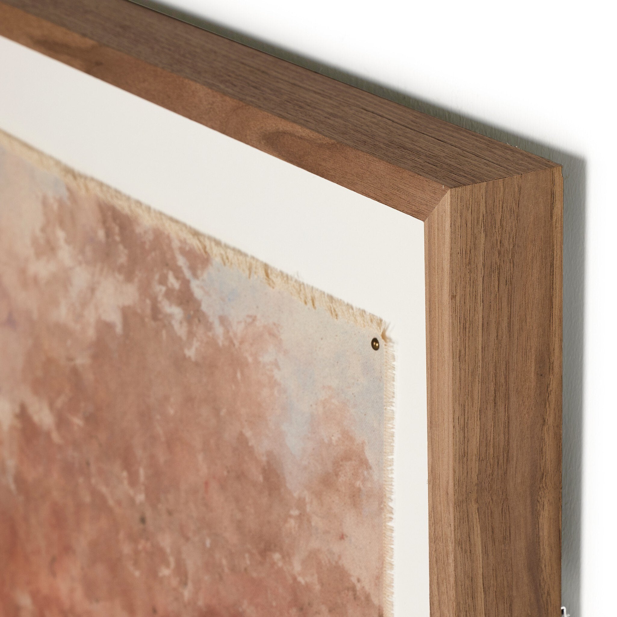 Close-up of a wooden frame with a textured wall in the background