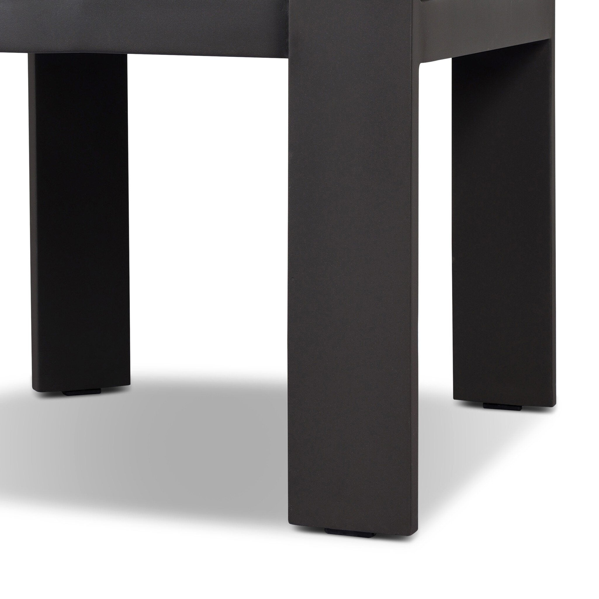 Close-up of a black chair leg on a white background