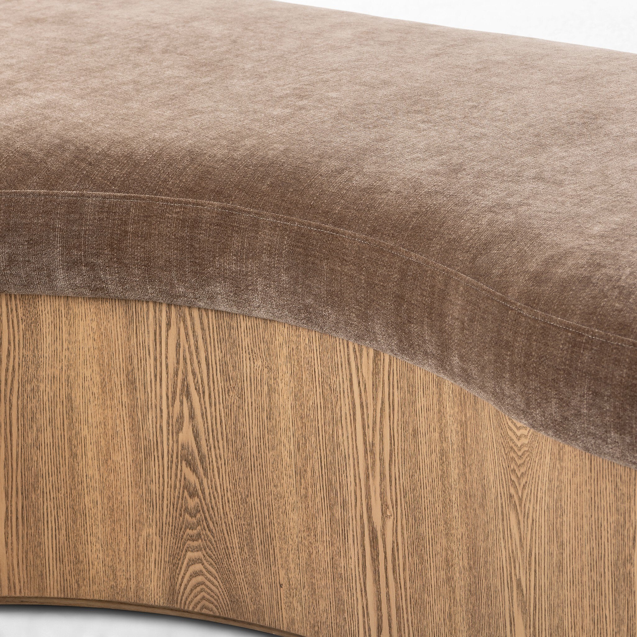 Close-up of a brown upholstered bench with wooden base
