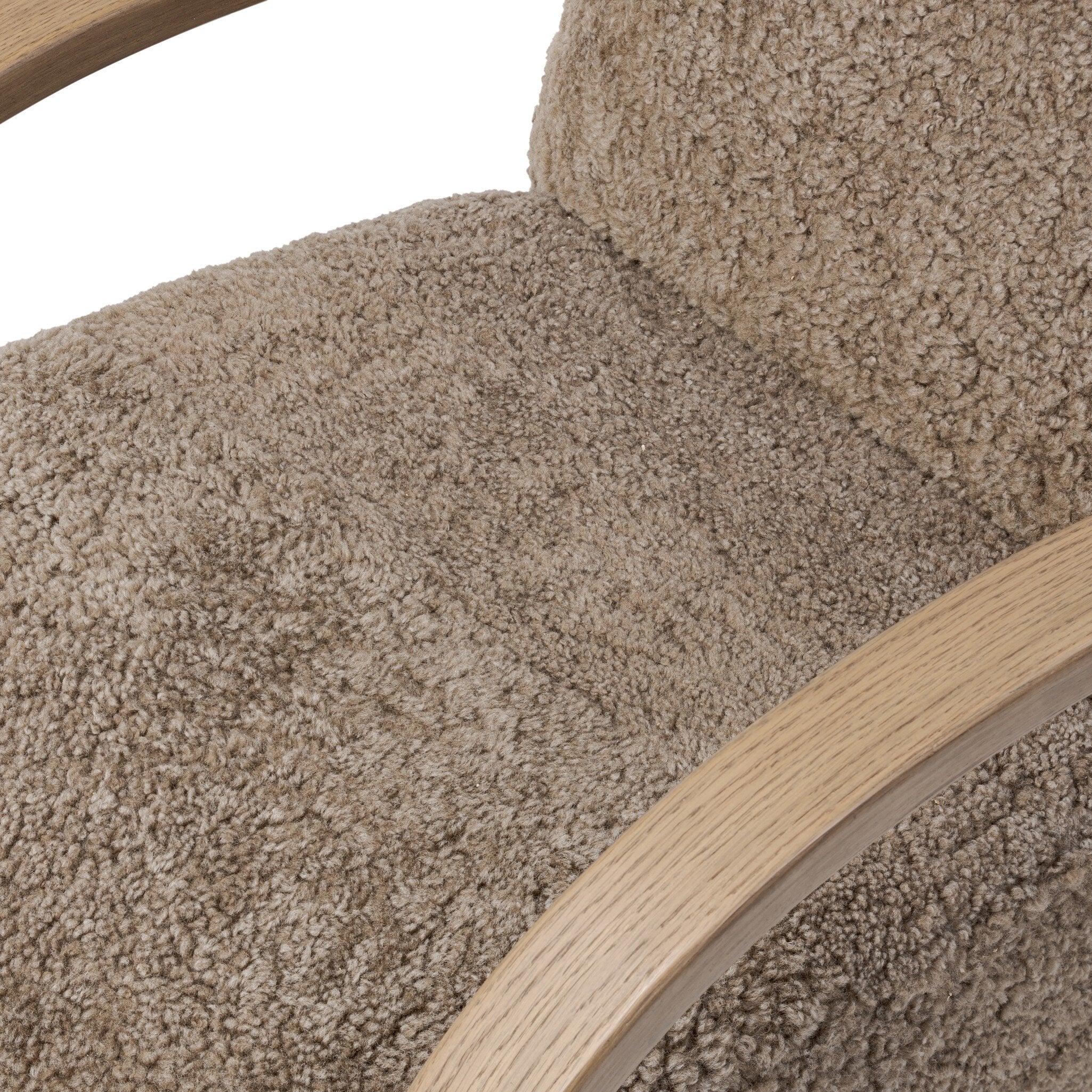Close-up of a textured beige cushion with wooden handles