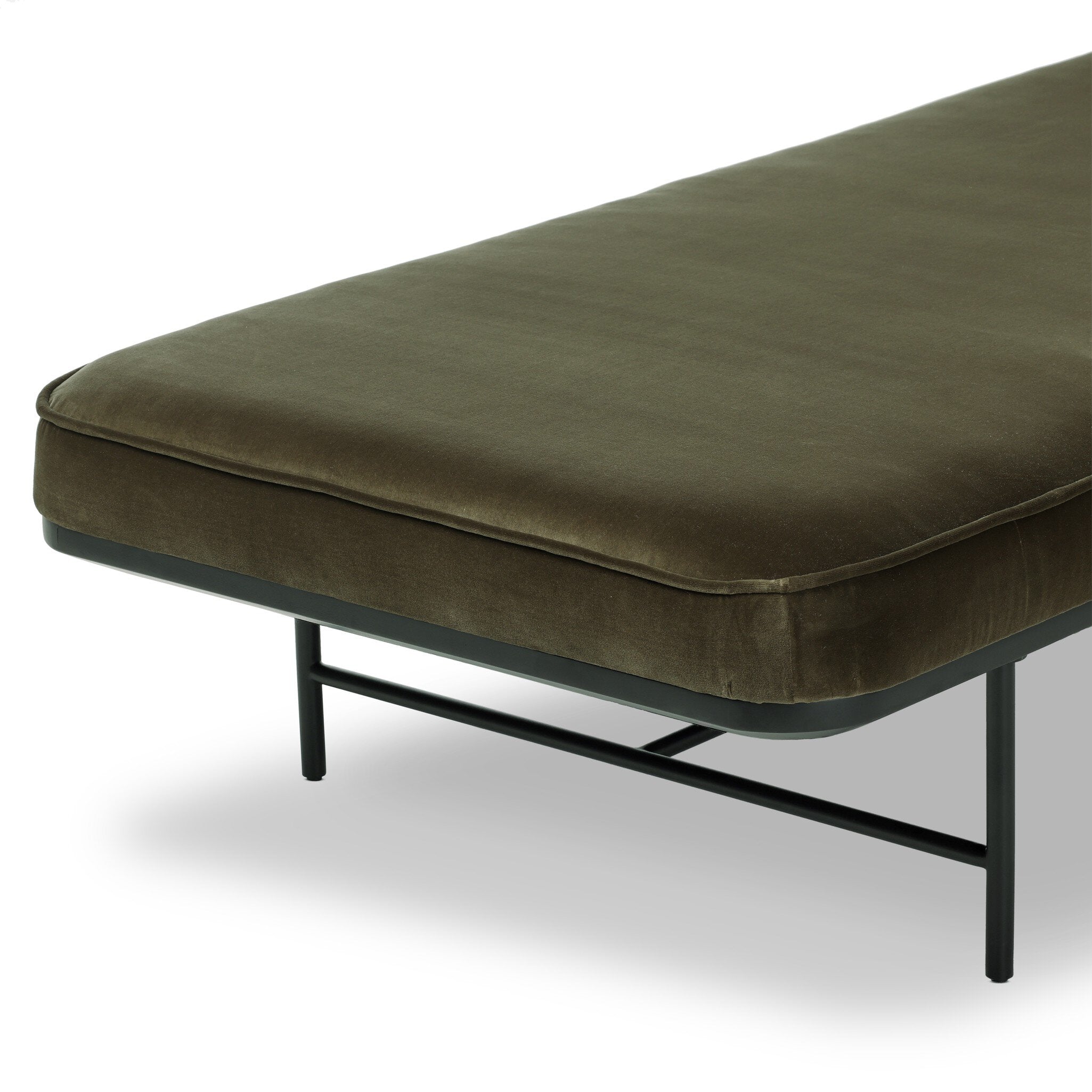 Green cushioned chaise bench with black metal frame on a white background