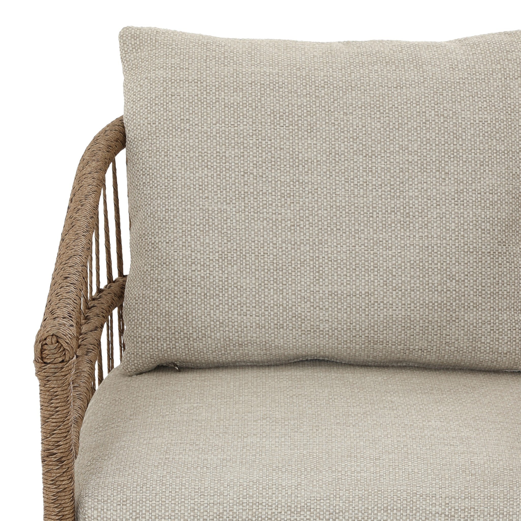 Textured cushion on a wicker chair with a neutral background