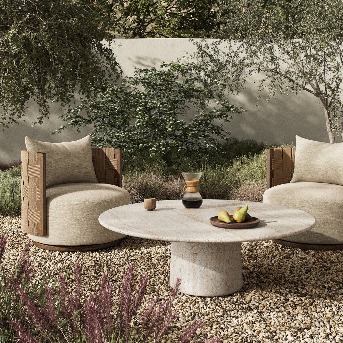 Outdoor furniture set with two chairs and a table in a natural setting.