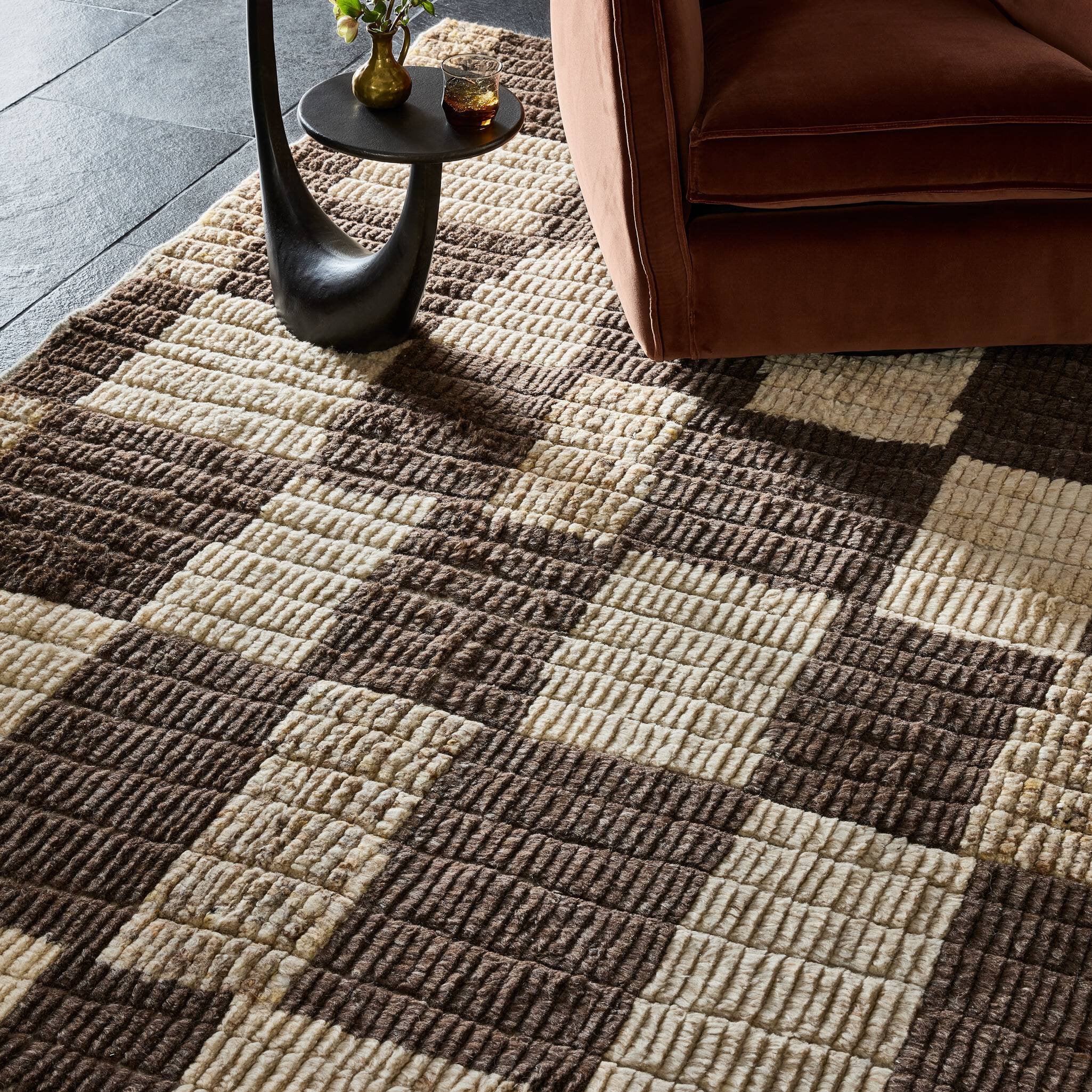 Patterned carpet with a checkered design in a living room setting.