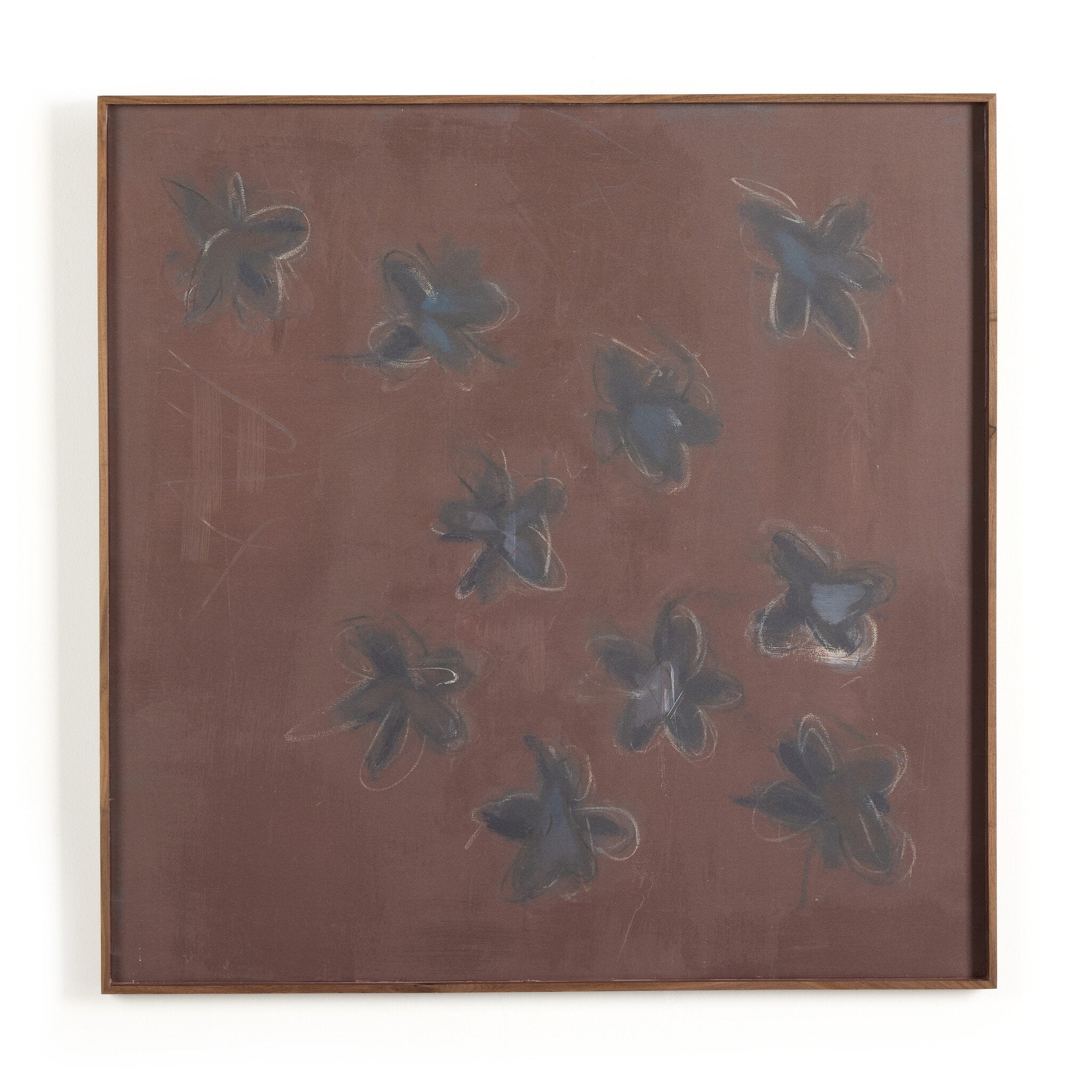 Framed artwork with abstract blue shapes on a brown background