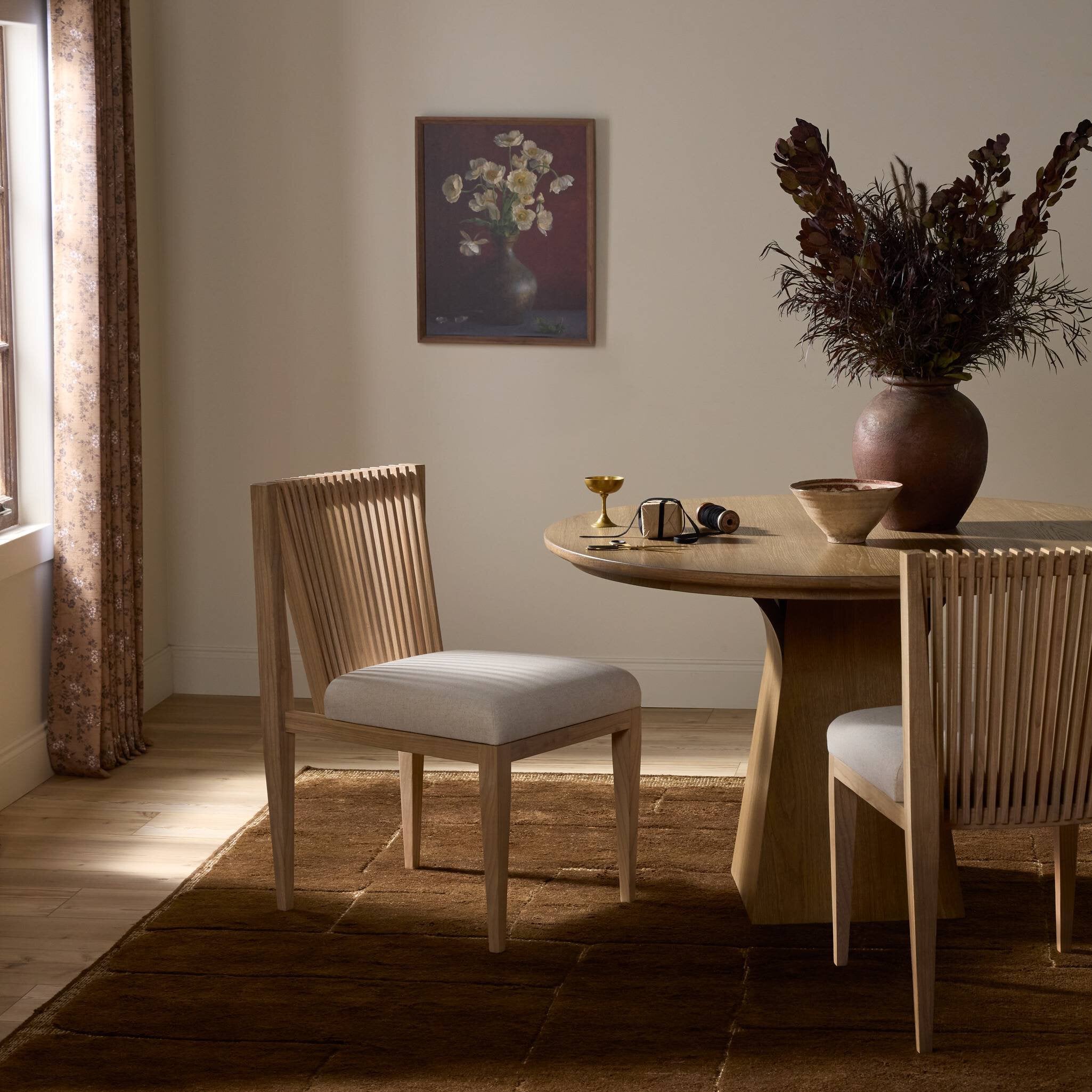 Dining room with wooden table, chairs, and decorative elements.