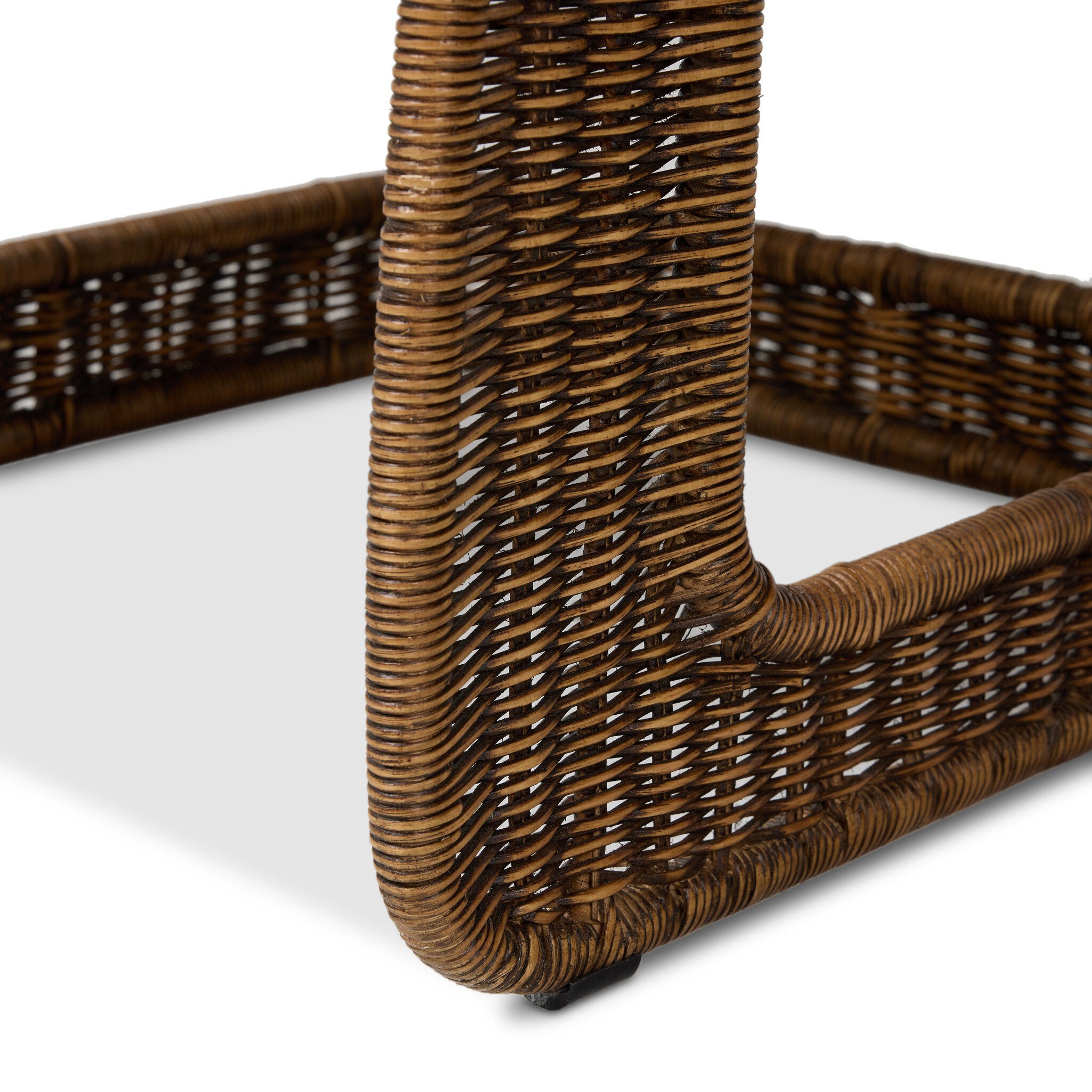 Close-up of a wicker chair leg on a white background