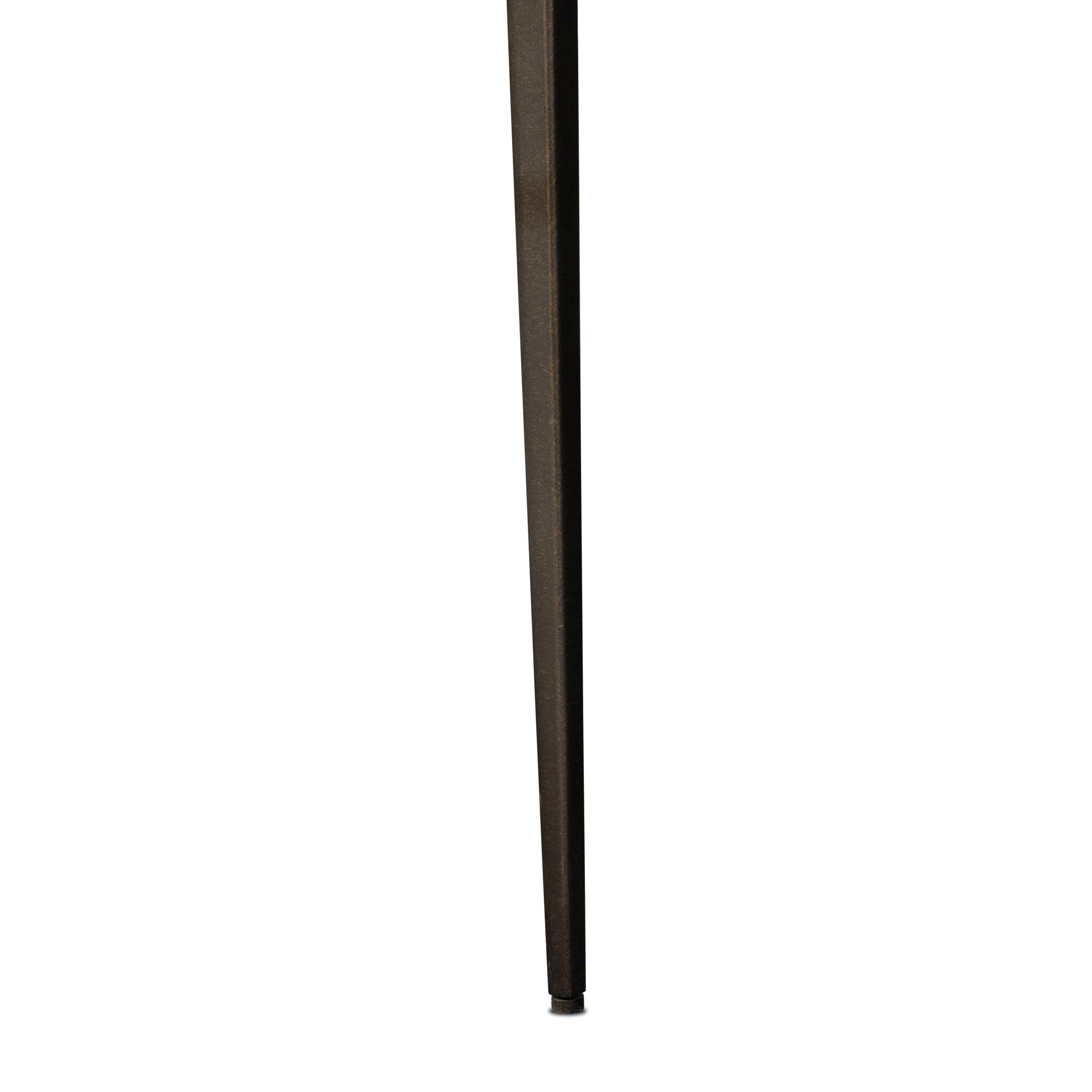 A close-up of a long, thin dark brown iron chair leg, shown vertically against a plain white background.