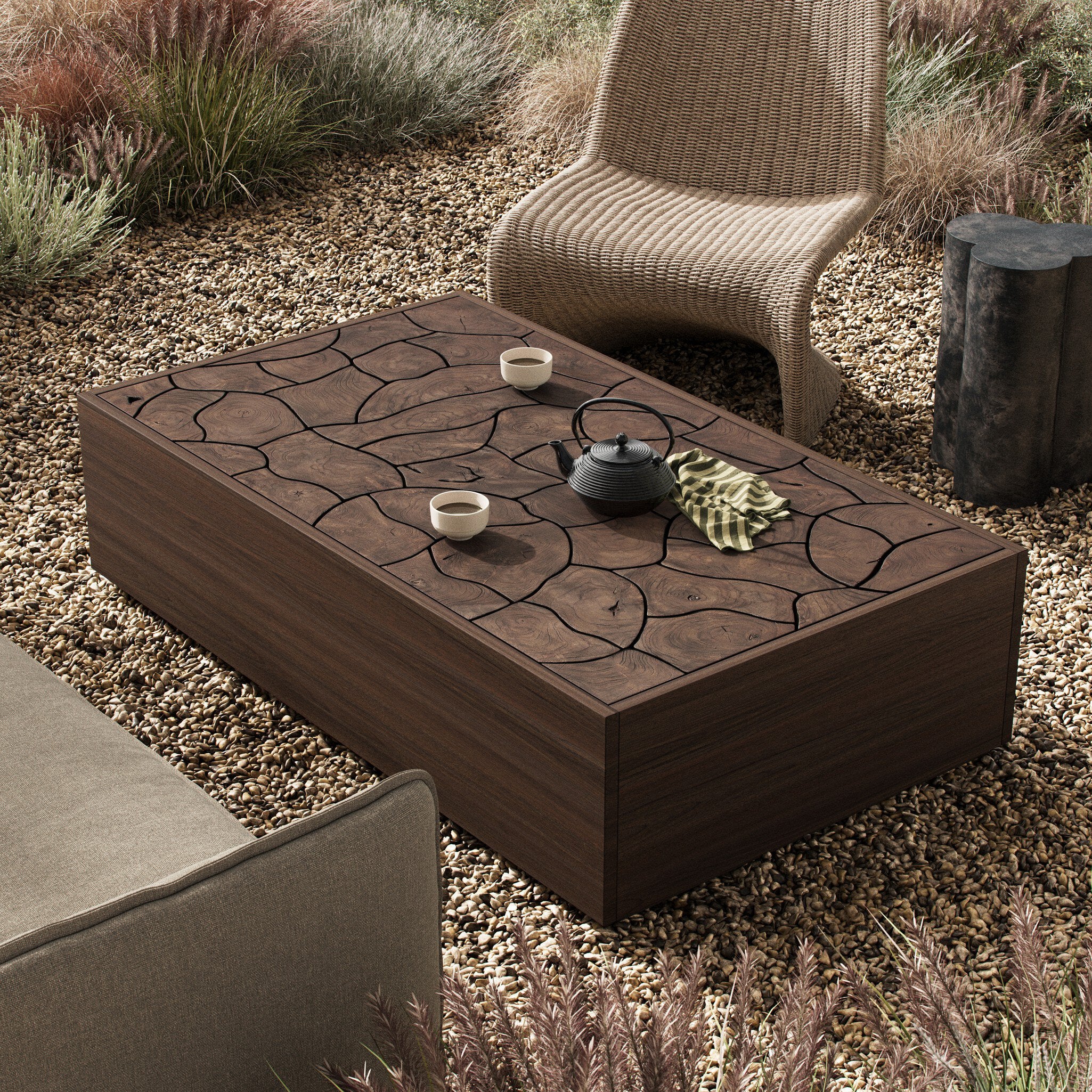 Outdoor setting with a stone-patterned teak coffee table, chair, and decorative elements.