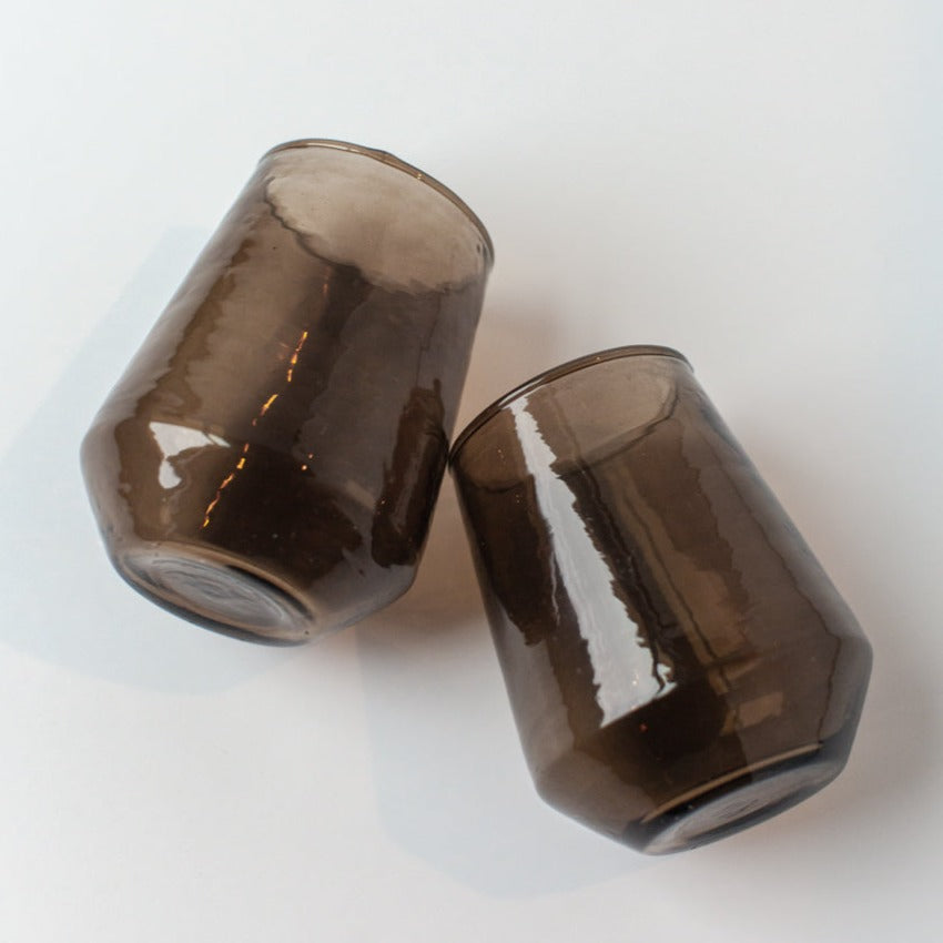 Two brown glass bottles on a white background