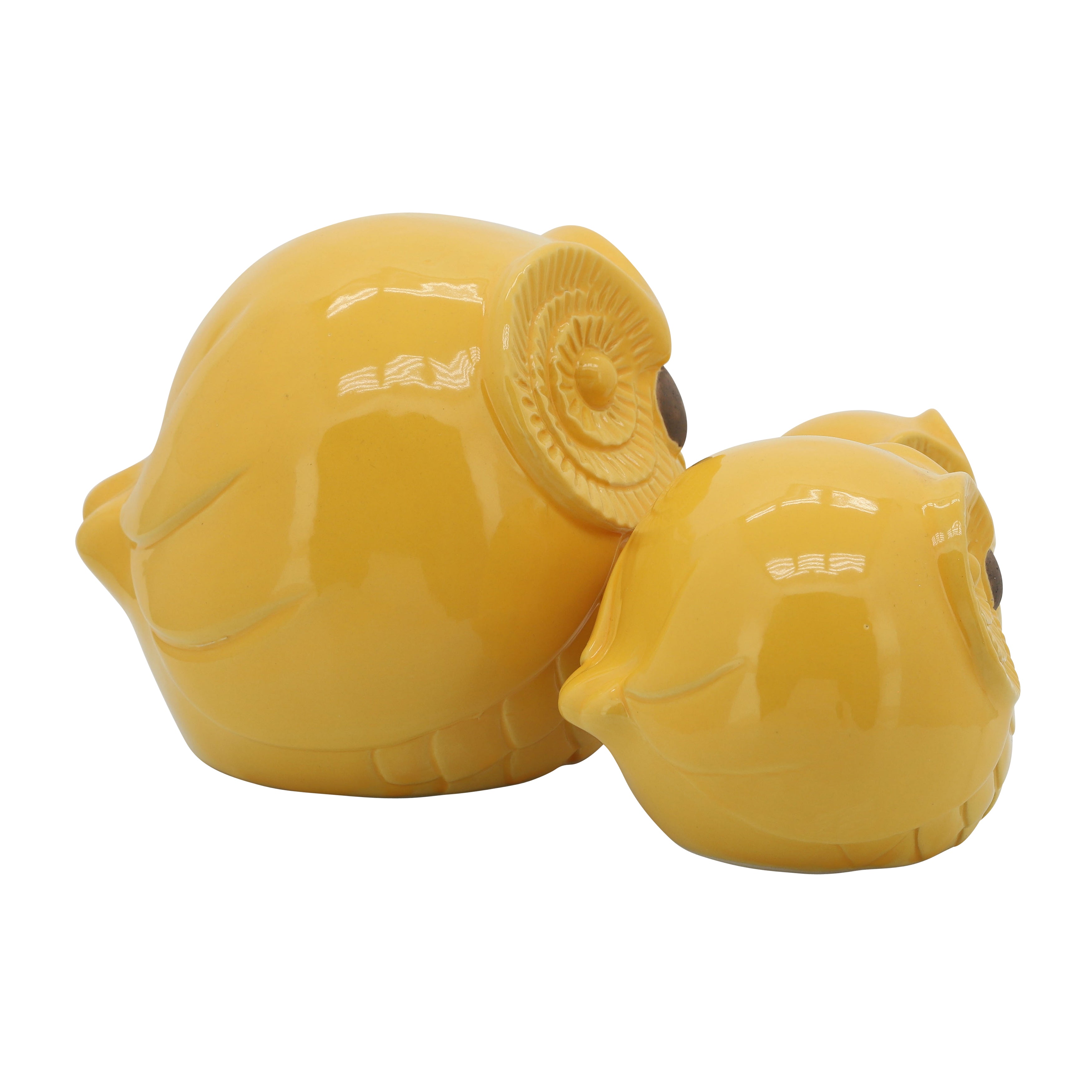 Two yellow ceramic owls on a white background